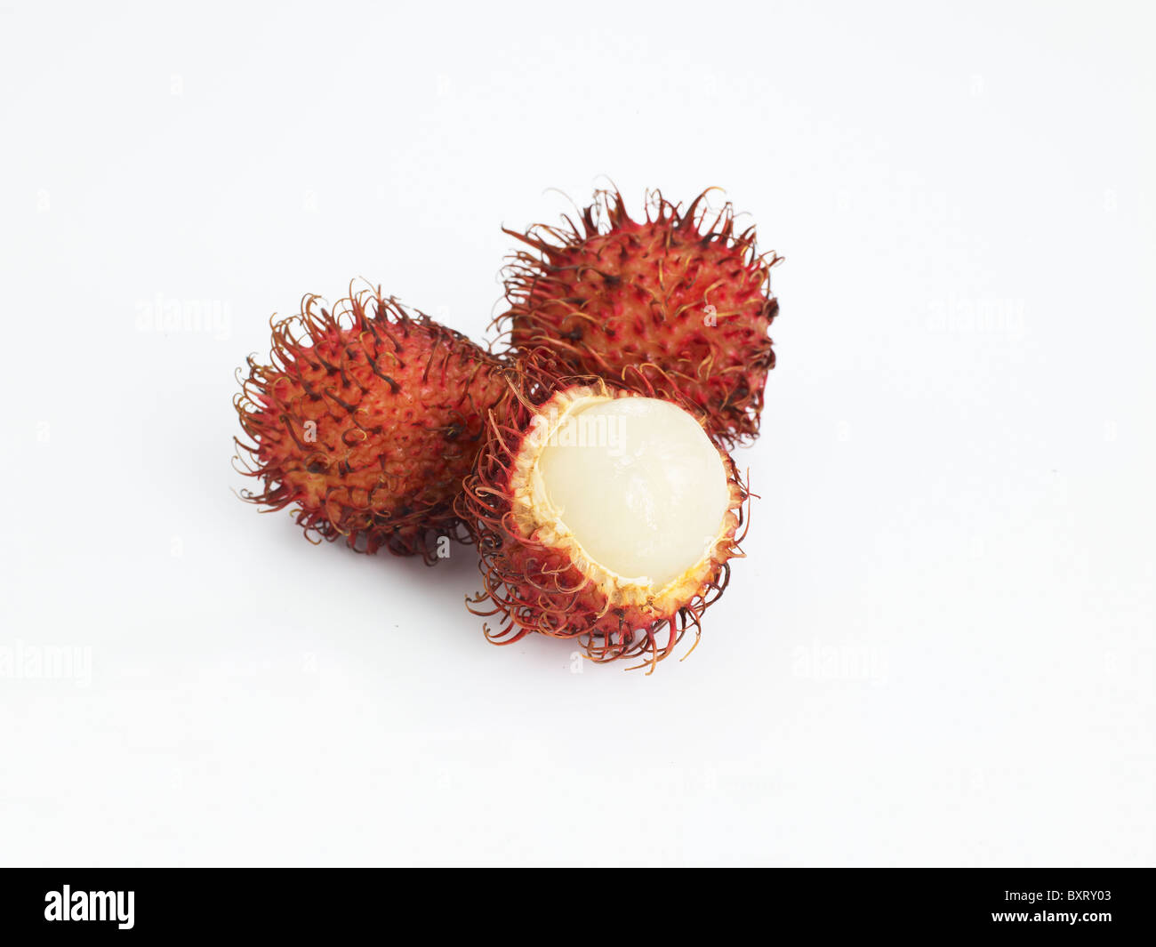 Rambutan whole and peeled on white background Stock Photo - Alamy