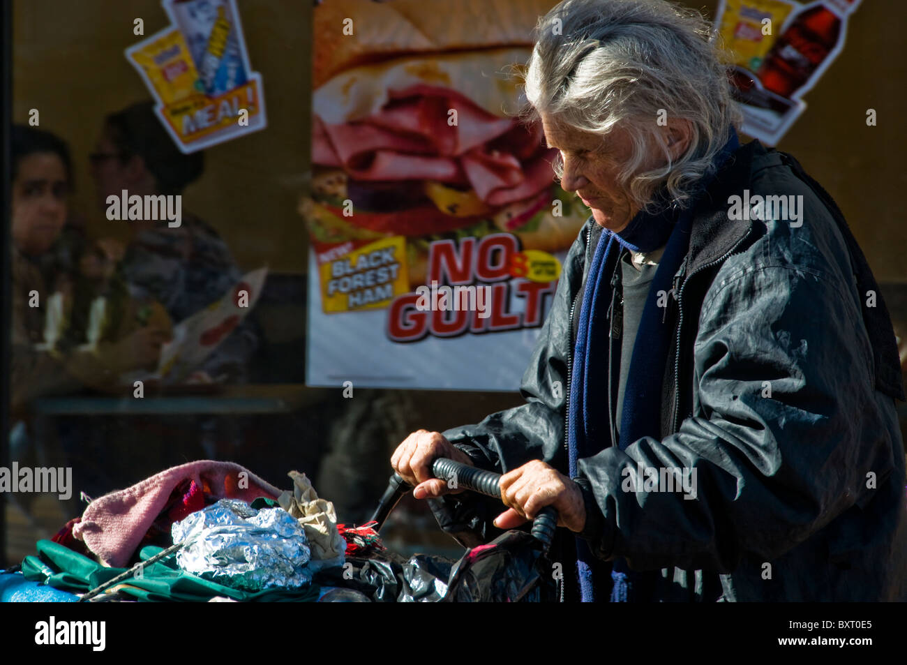 Homeless woman walking on city street in San Francisco CA USA California Stock Photo