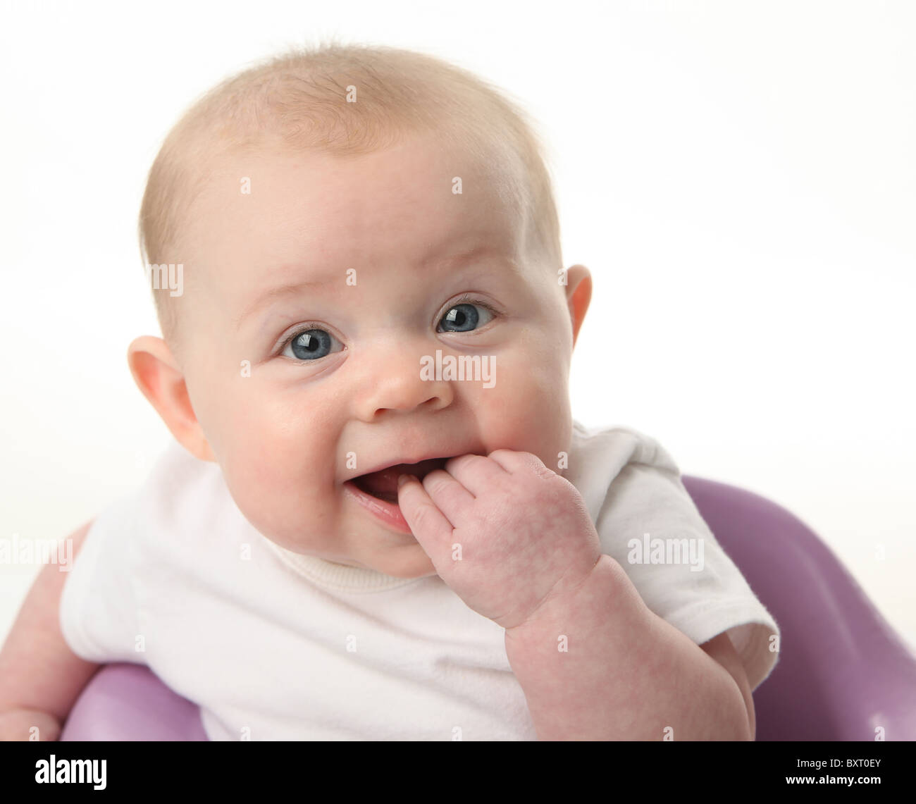 Close up portrait of a cute baby chewing on fingers on white background