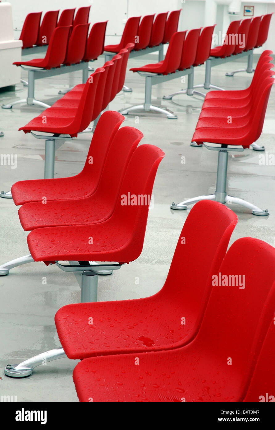 lot of wet red modern chair outside Stock Photo