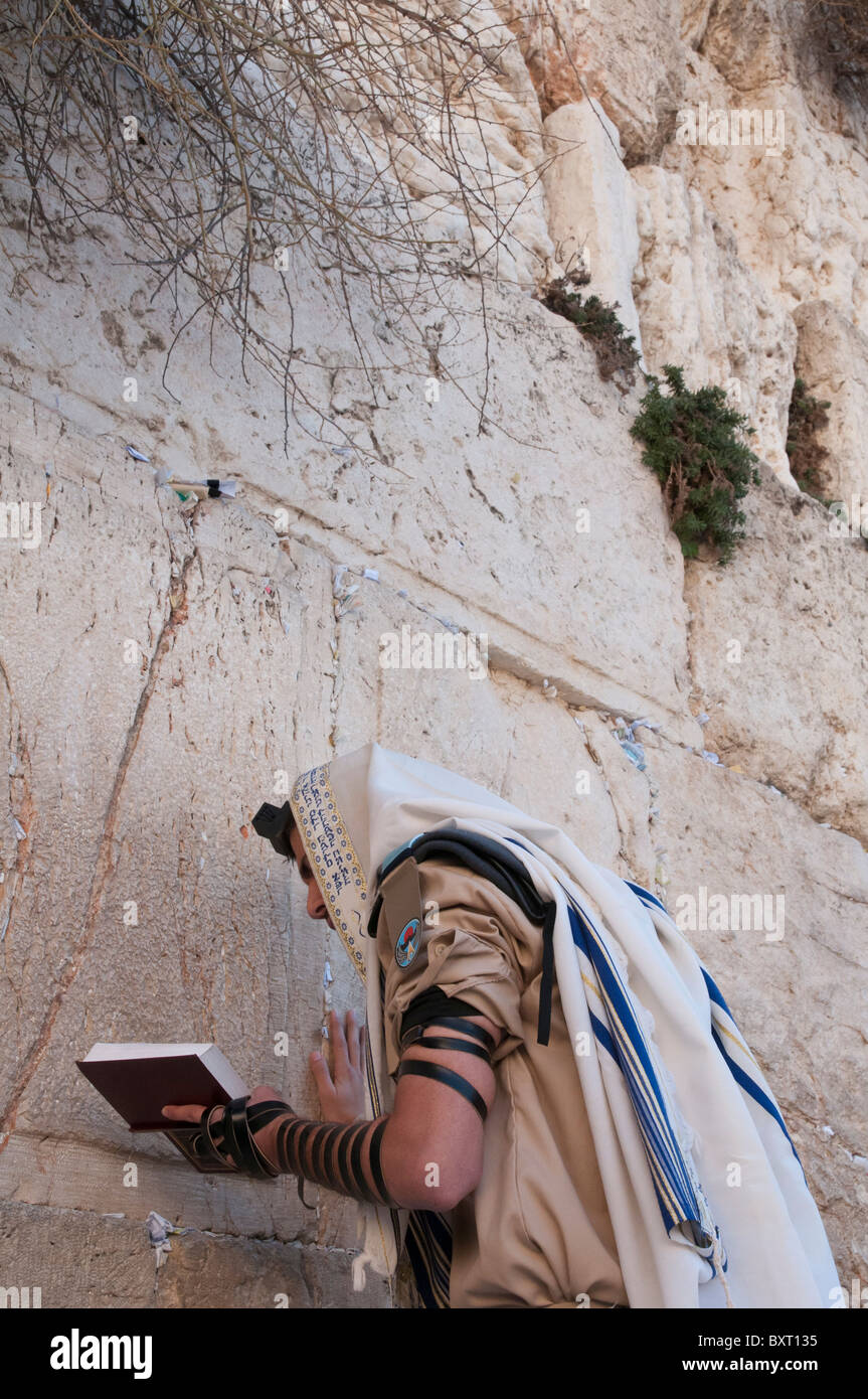 Western Wall. Soldier praying at wall with tefillin and talit. Jerusalem Old City Stock Photo