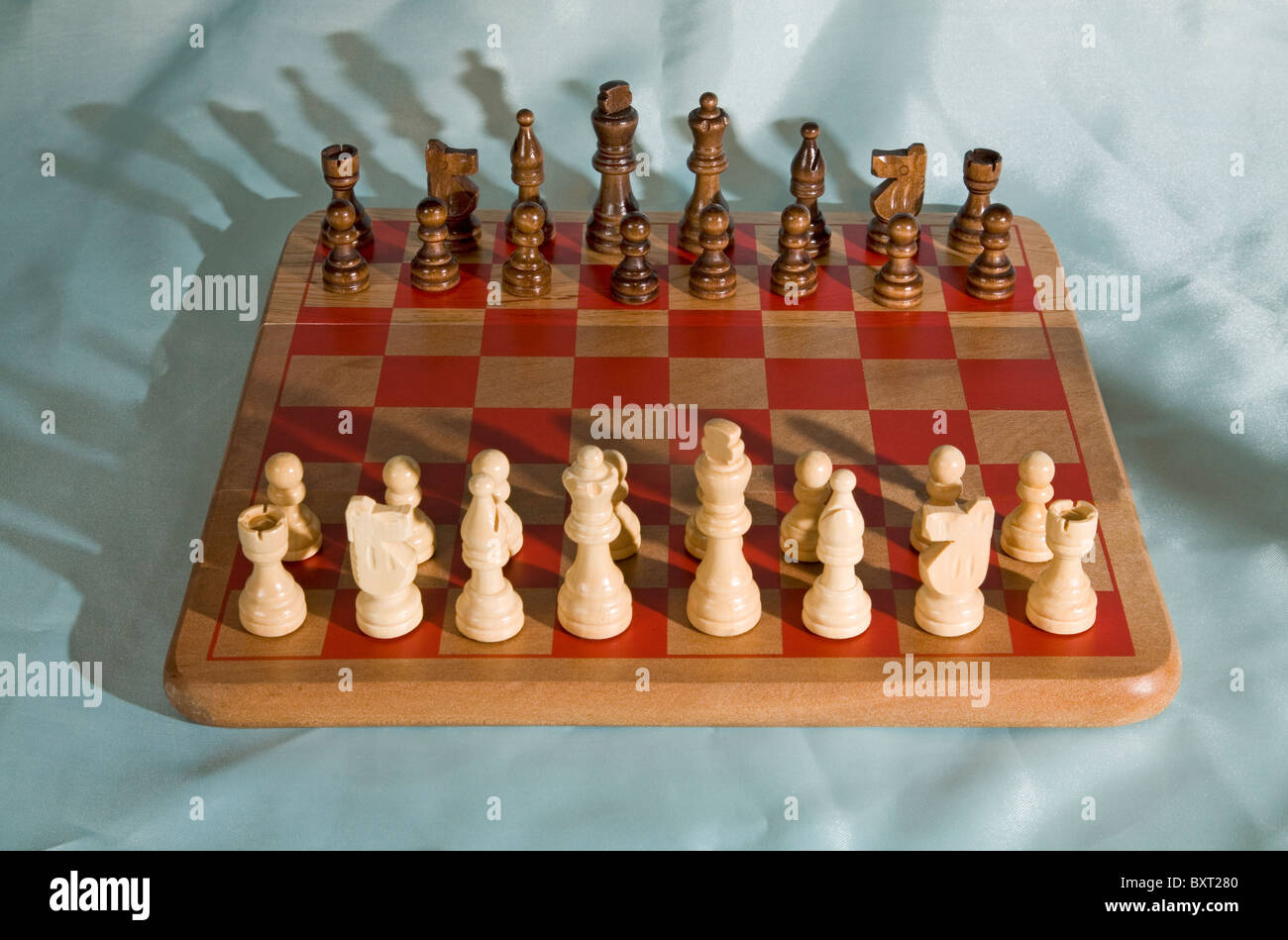 Chess pieces in starting position on a wooden Board Stock Photo by  ©Rostislavv 141335034