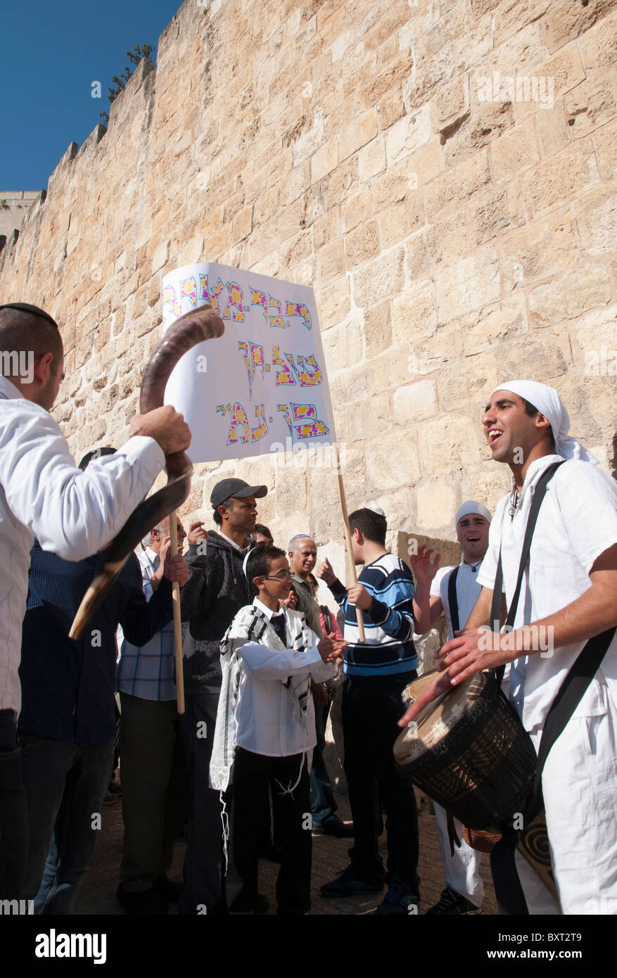 Drummers accompanying a youngster to his bar Mitzvah ceremony by city walls. Jerusalem Old City Stock Photo