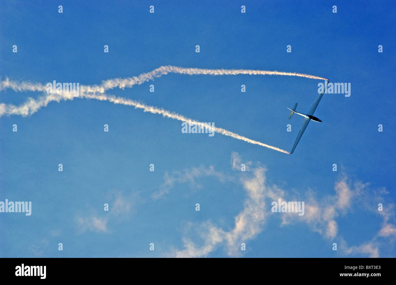 Shoreham air show - a glider stunt plane trails smoke. Stock Photo