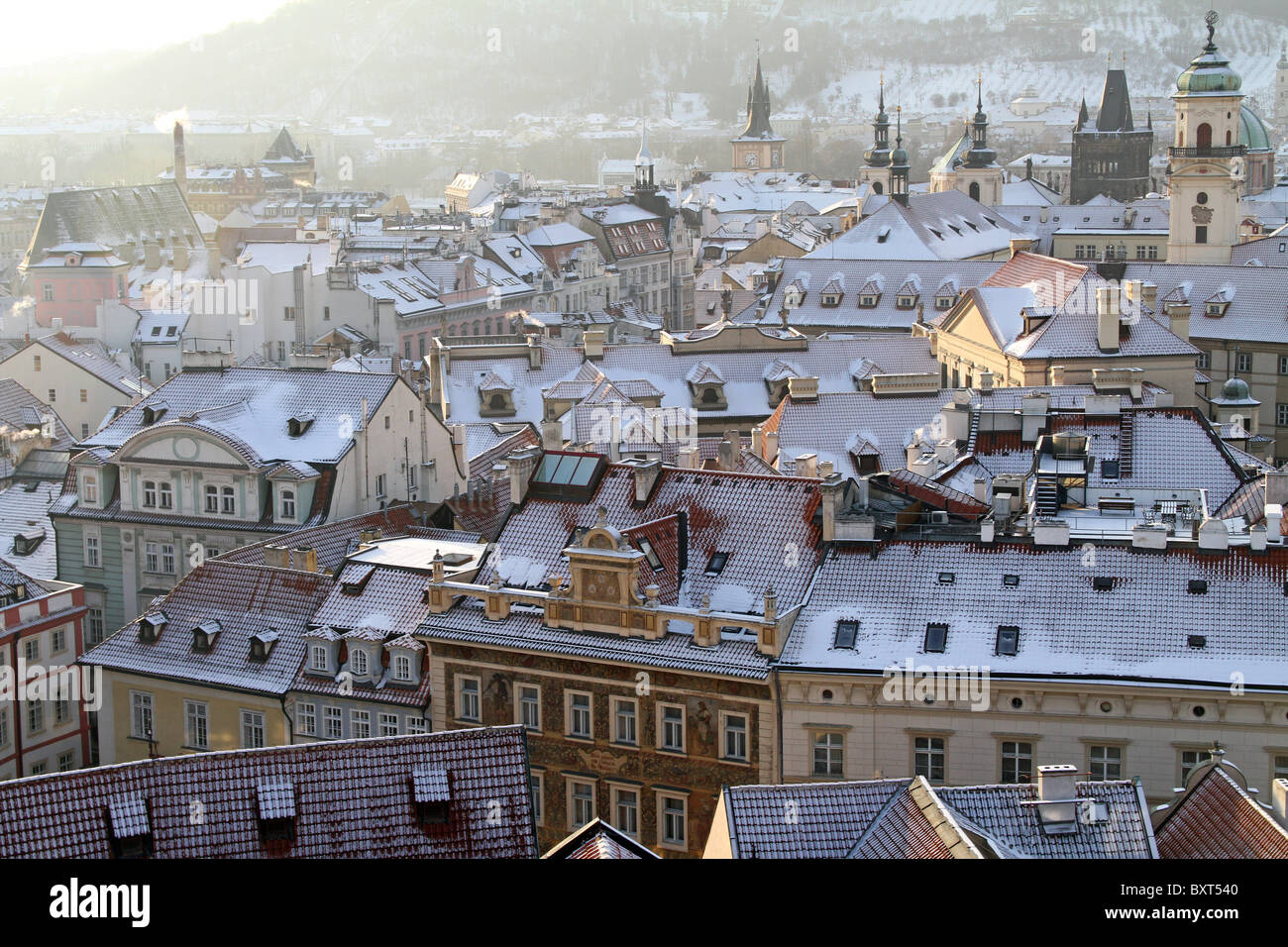 The roofs and rooftops of the skyline in Prague, Czech Republic with snow in winter Stock Photo