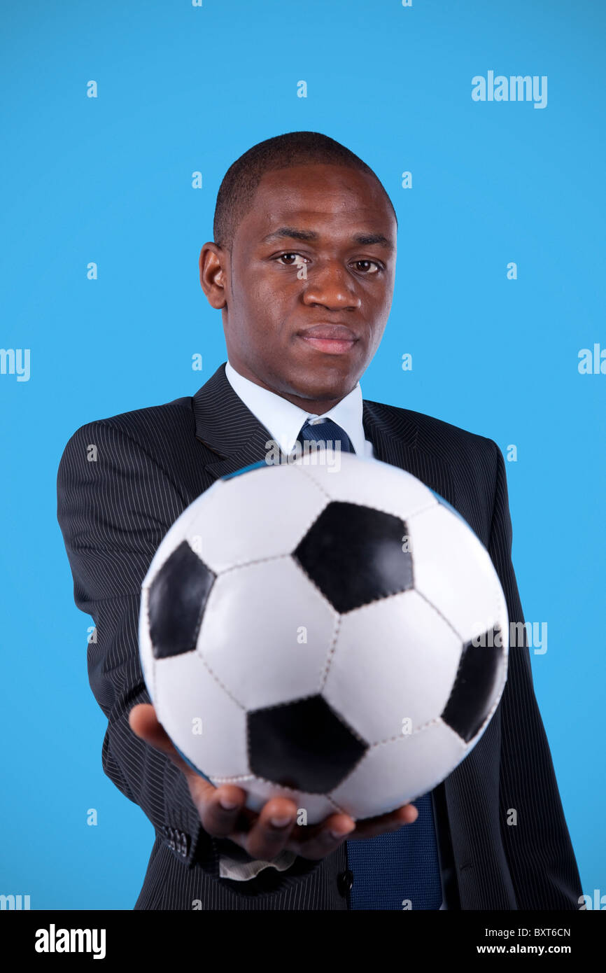 African businessman holding a soccer ball Stock Photo - Alamy