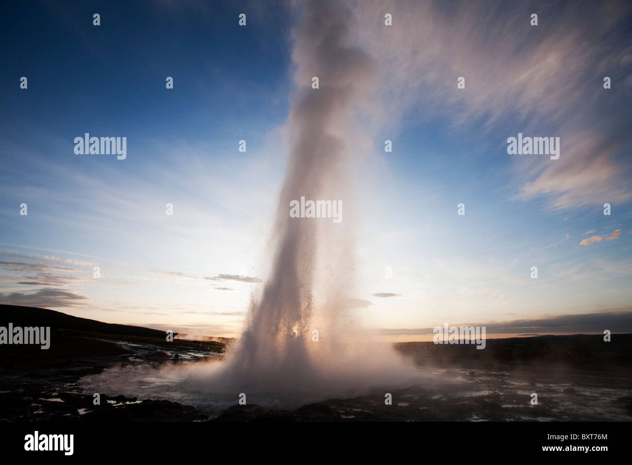Iceland, Geysir, Strokkur Geyser erupting at sunrise on summer morning Stock Photo