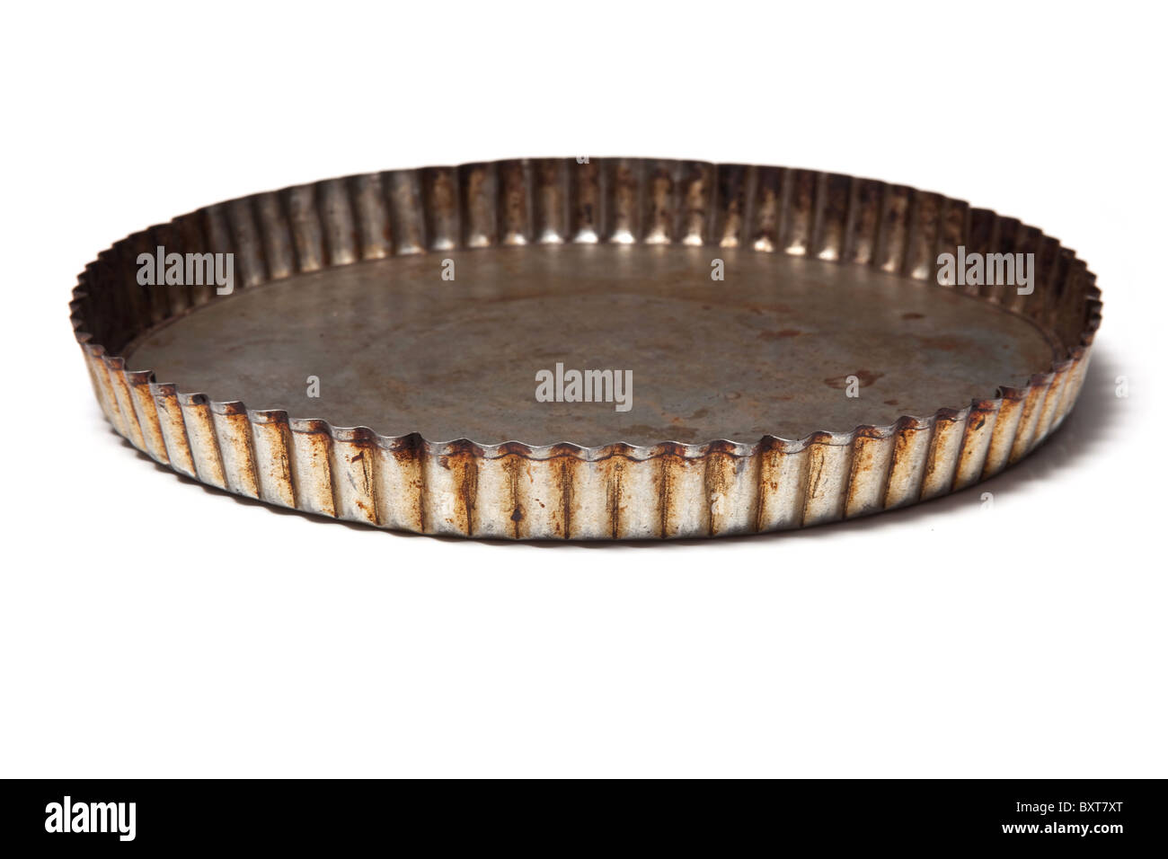 Flan baking tin isolated on a white studio background. Stock Photo