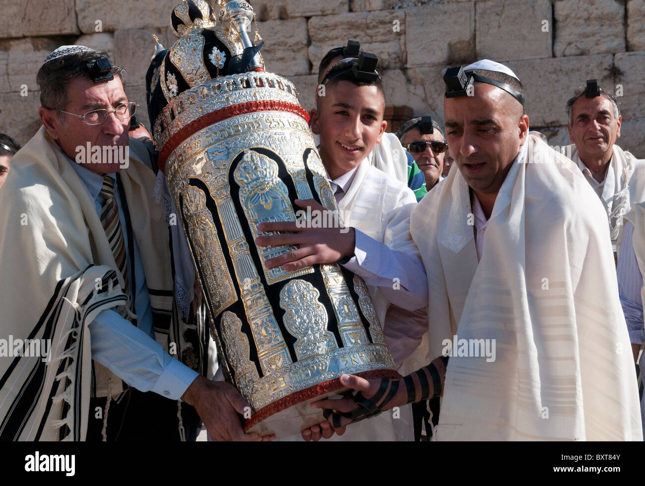 Western Wall. youngster carrying torah scrolls on his bar mitzvah