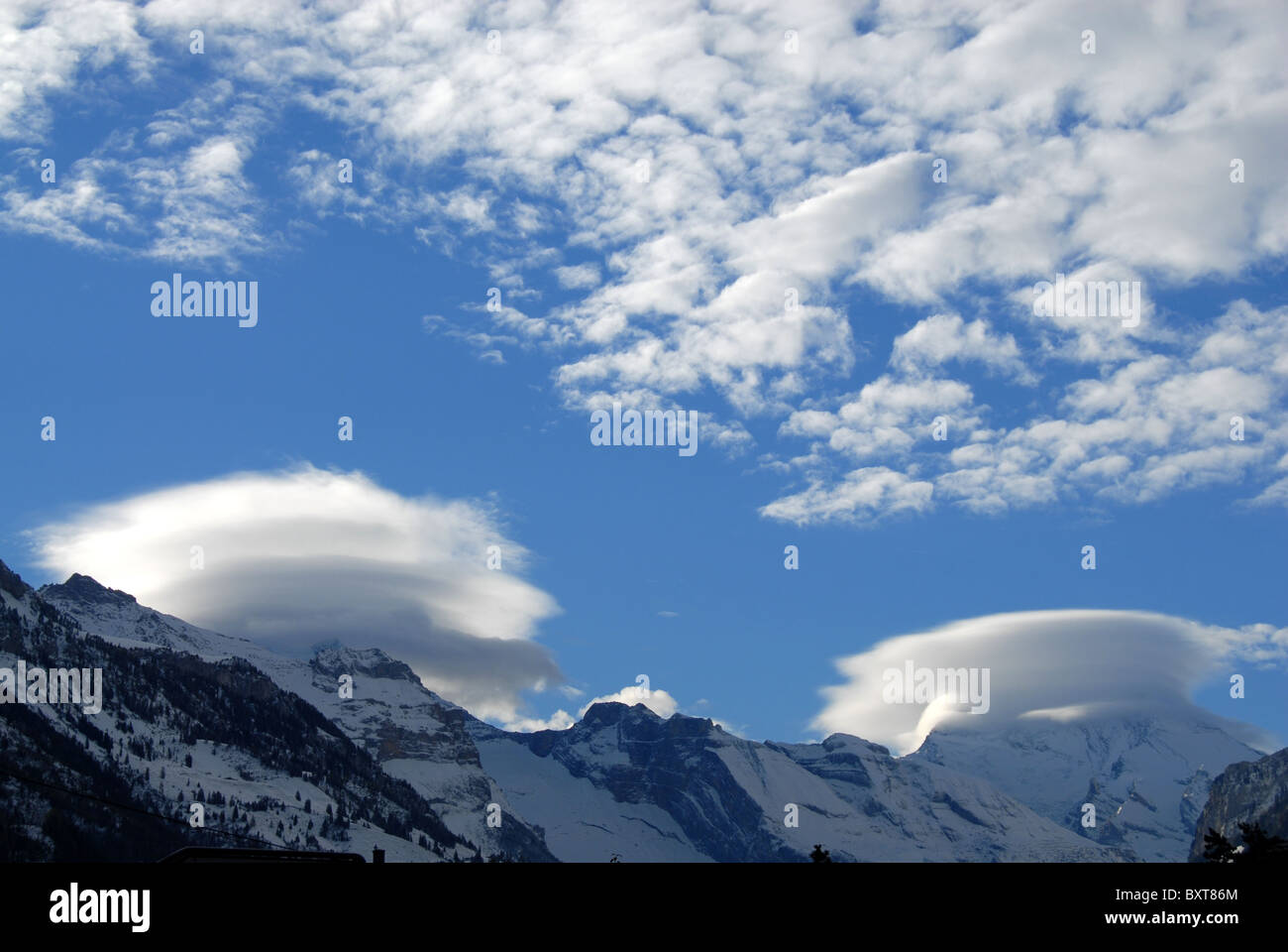 Foehn clouds and altocumulus above Bernese alps, Switzerland Stock Photo