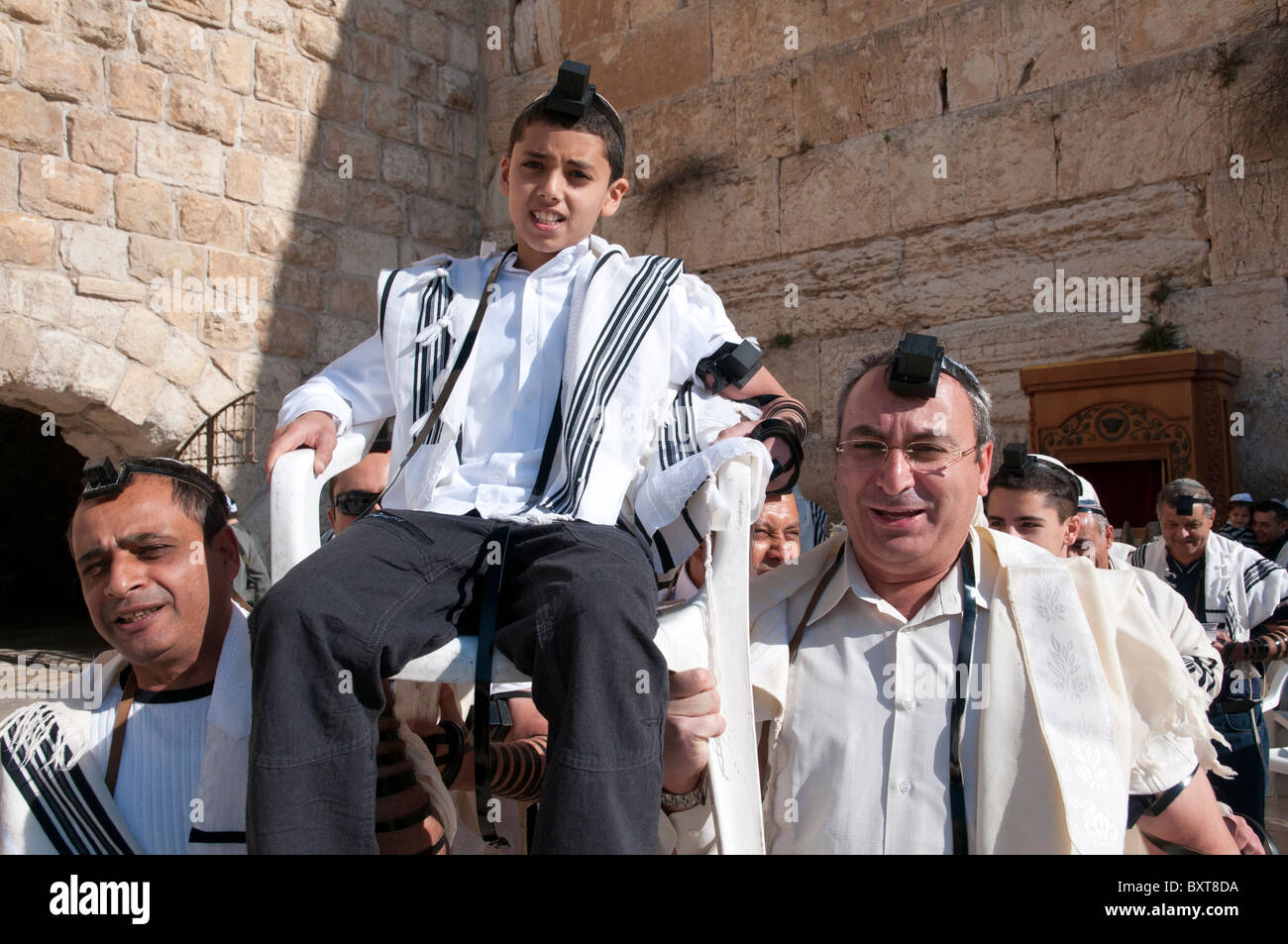 Western Wall. youngster being lifted on a chair during his Bar Mitzvah