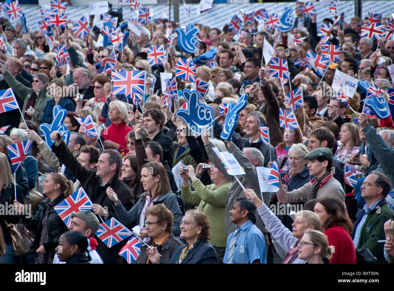 LARGE CROWED OF PEOPLE HOLDING AND WAVEING  UNION JACK IN TRAFALGAR SQUARE CHEARING  FOR THE BRITISH OLYMPIANS Stock Photo