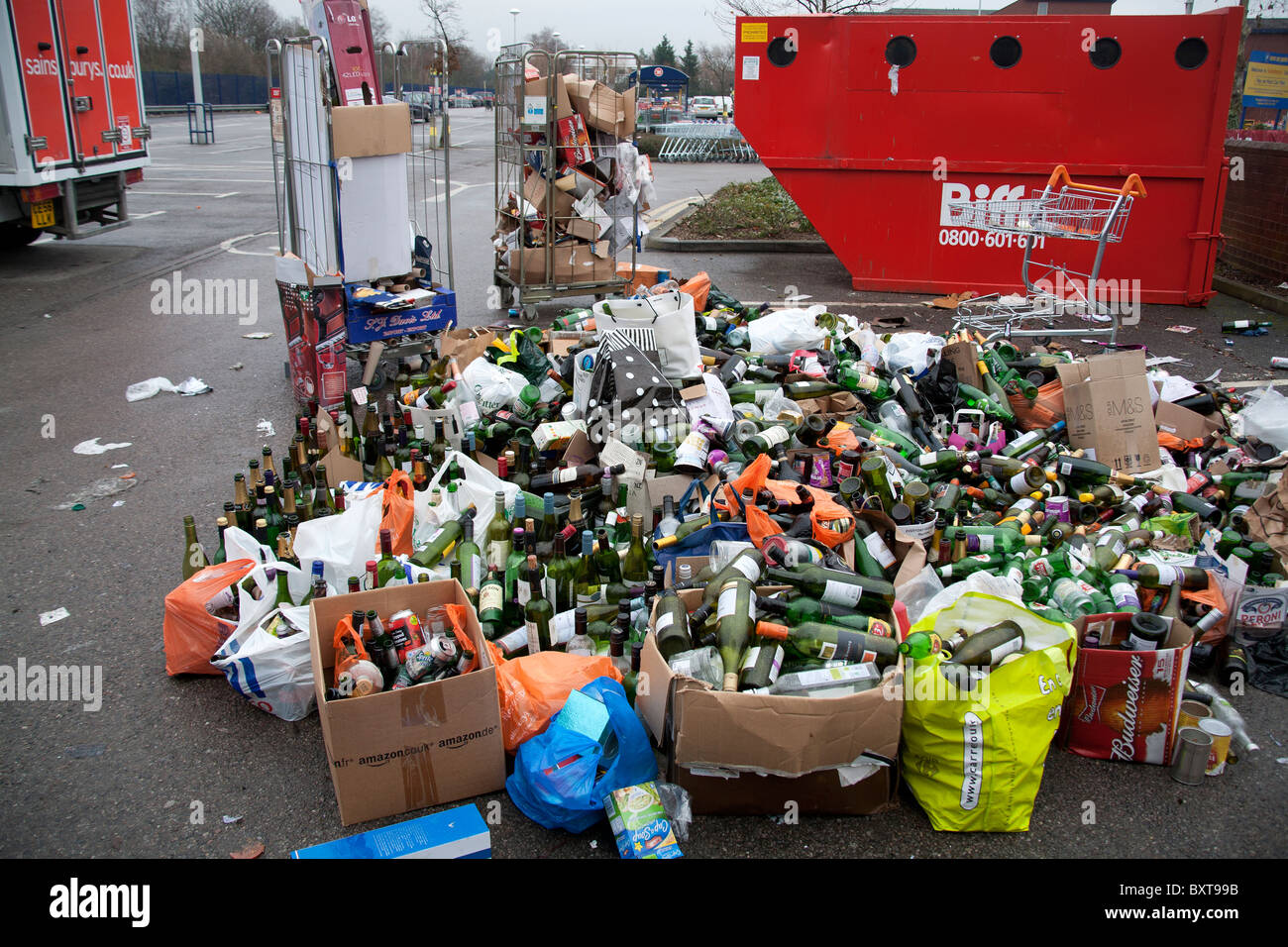 Overflow of uncollected bottles after Christmas Sainsbury's Car Park recycling depot, Chiswick, London W4 Stock Photo