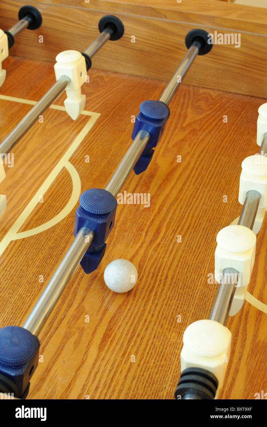 Foosball table in a carpeted room Stock Photo