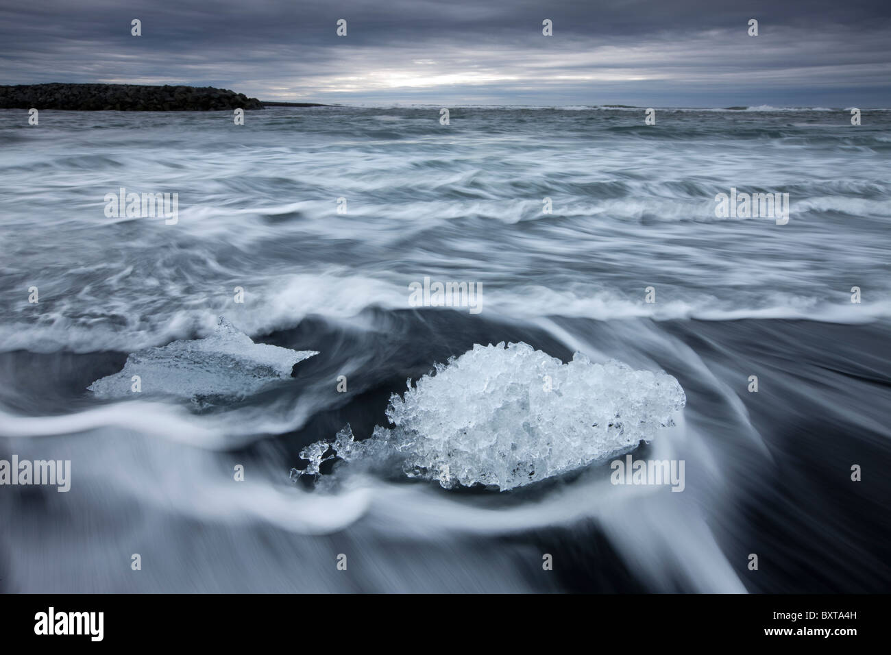 Iceland Skaftafell National Park Motion blur image of icebergs from Vatnajokull Glacier in waves from North Atlantic Ocean at Stock Photo