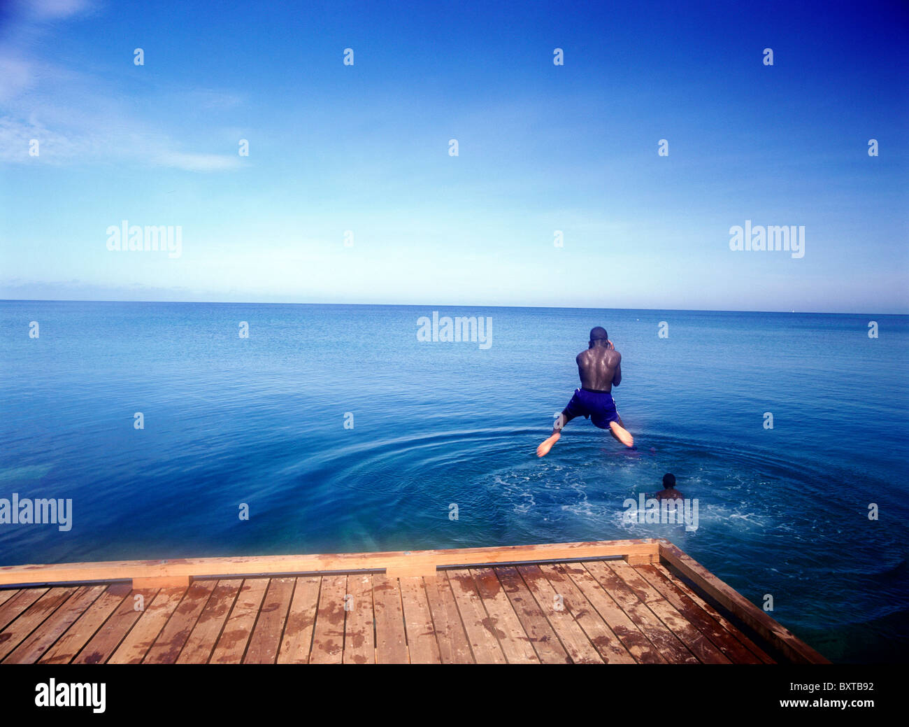 Boy jumping off pier hires stock photography and images Alamy