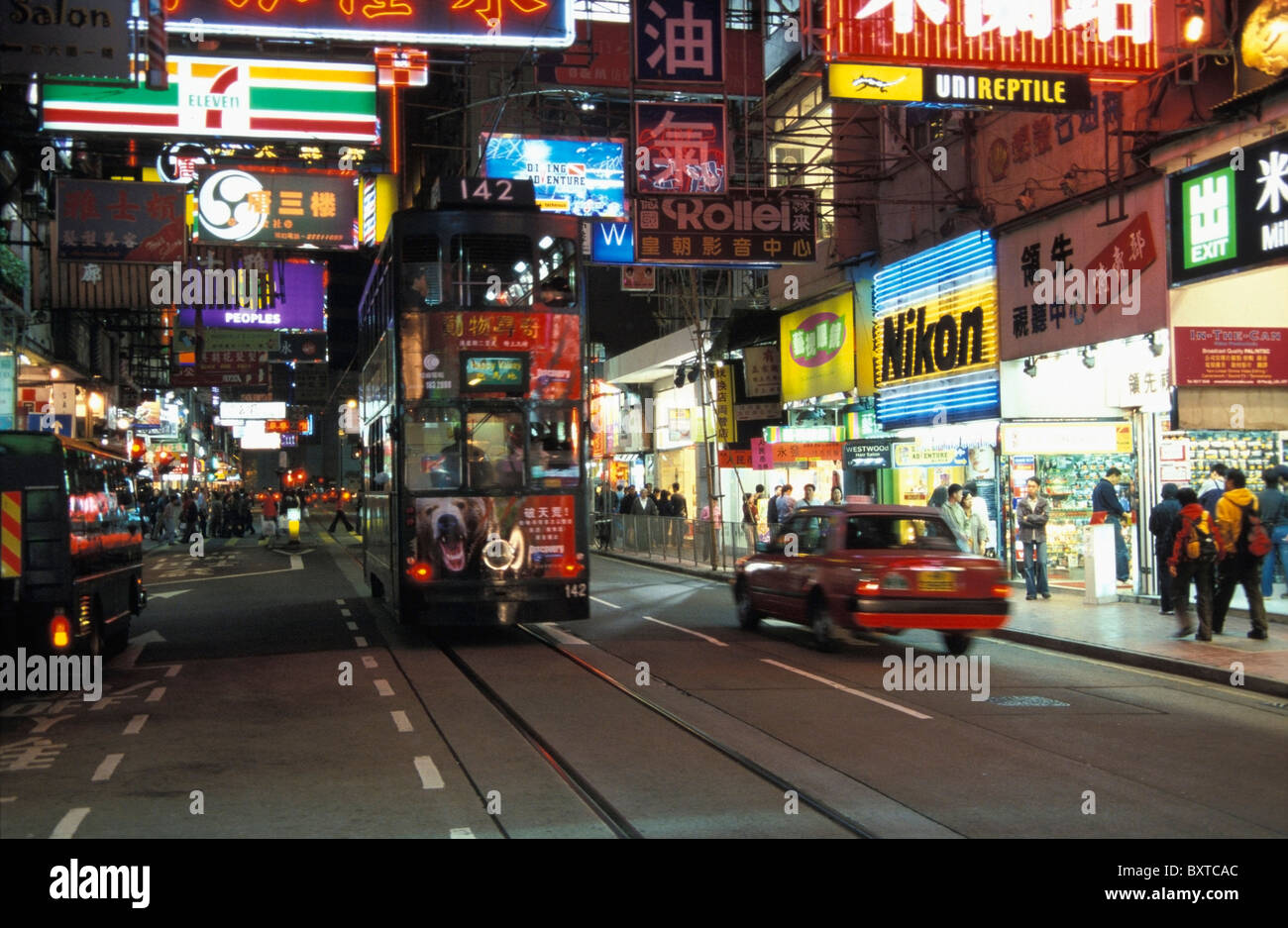 Busy Night Street Scene With Neon Signs Stock Photo - Alamy