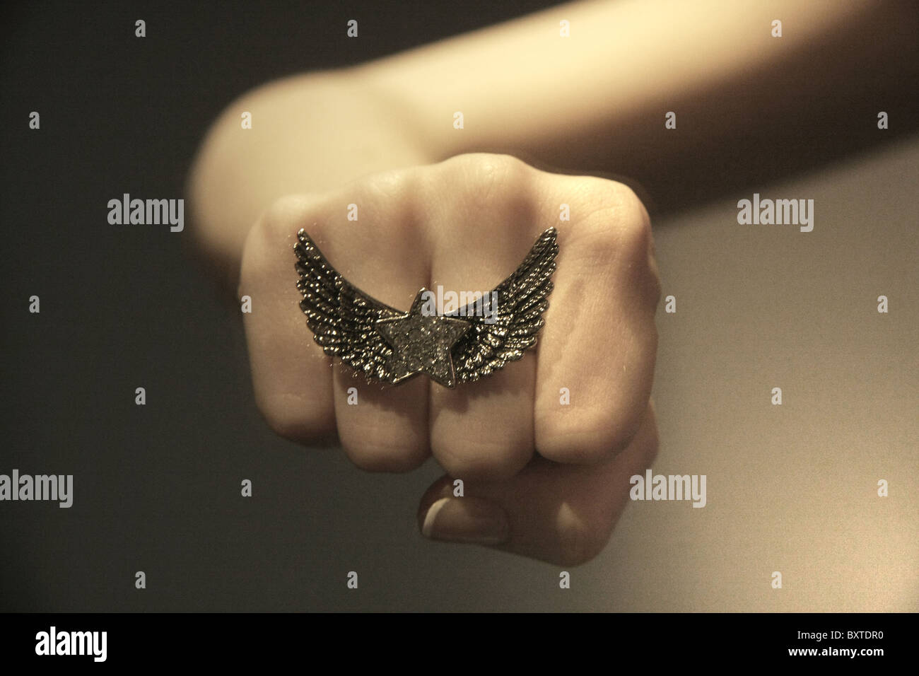 Woman's fist with a ring on it Stock Photo - Alamy