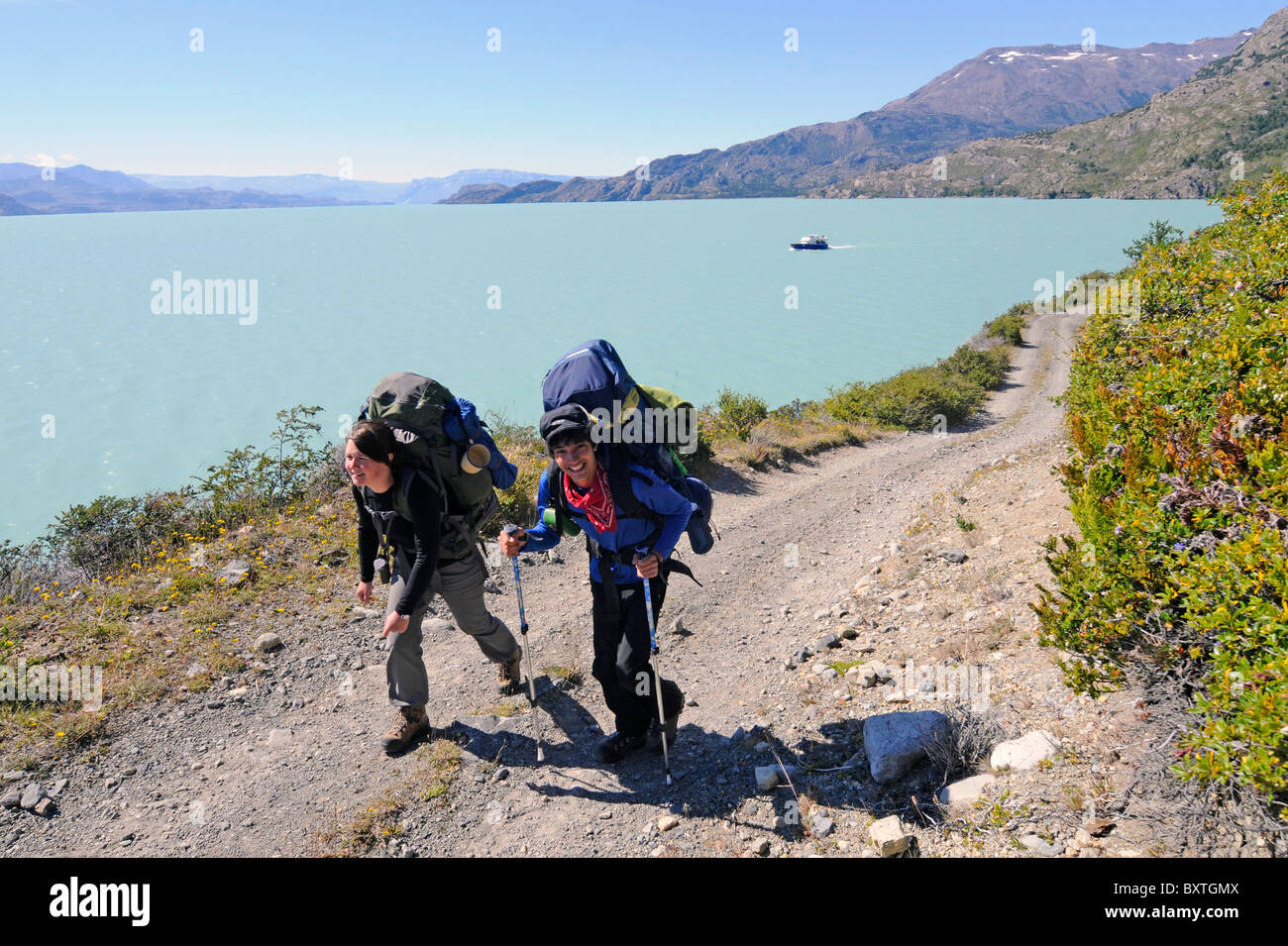 Hikers trekking on the shore of lake o'higgins in Patagonia, southern Chile. Stock Photo