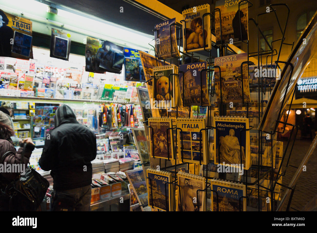 Rome, night photo of news agent with calendars and customers Stock Photo