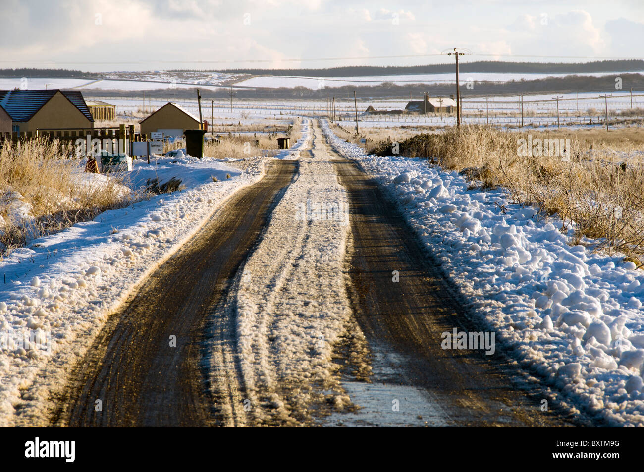 Snow covered road at Scarfskerry, Caithness, Scotland, UK Stock Photo