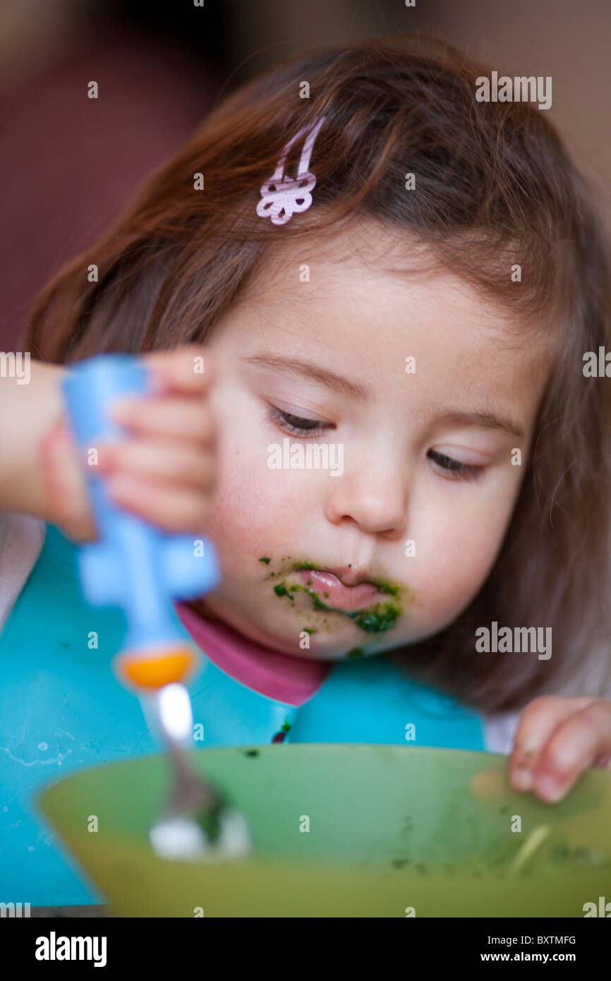 18 month old girl eating from a bowl Stock Photo Alamy