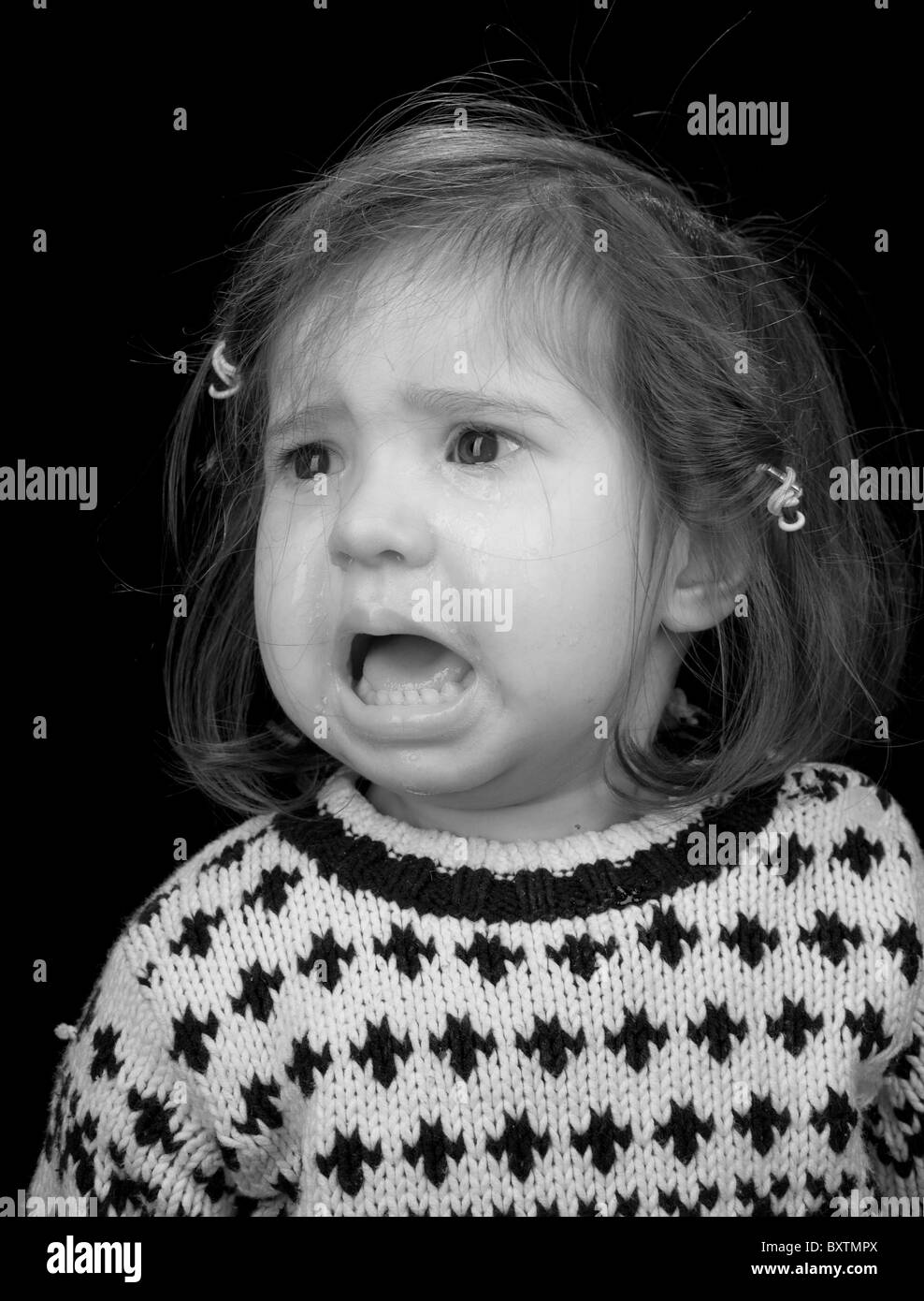 B&W portrait of a young girl crying Stock Photo