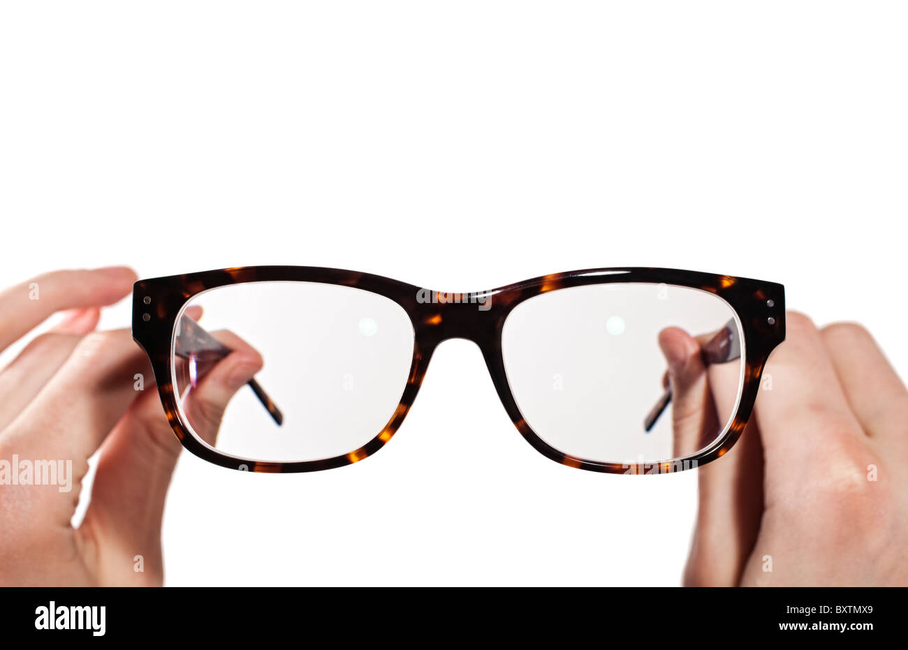 glasses with horn-rimmed in human hands isolated Stock Photo