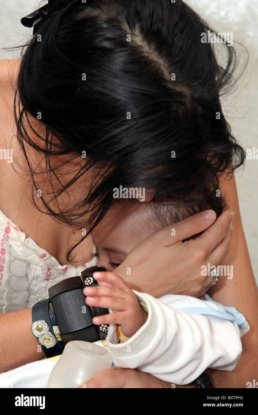Mother and baby daughter cuddling Stock Photo