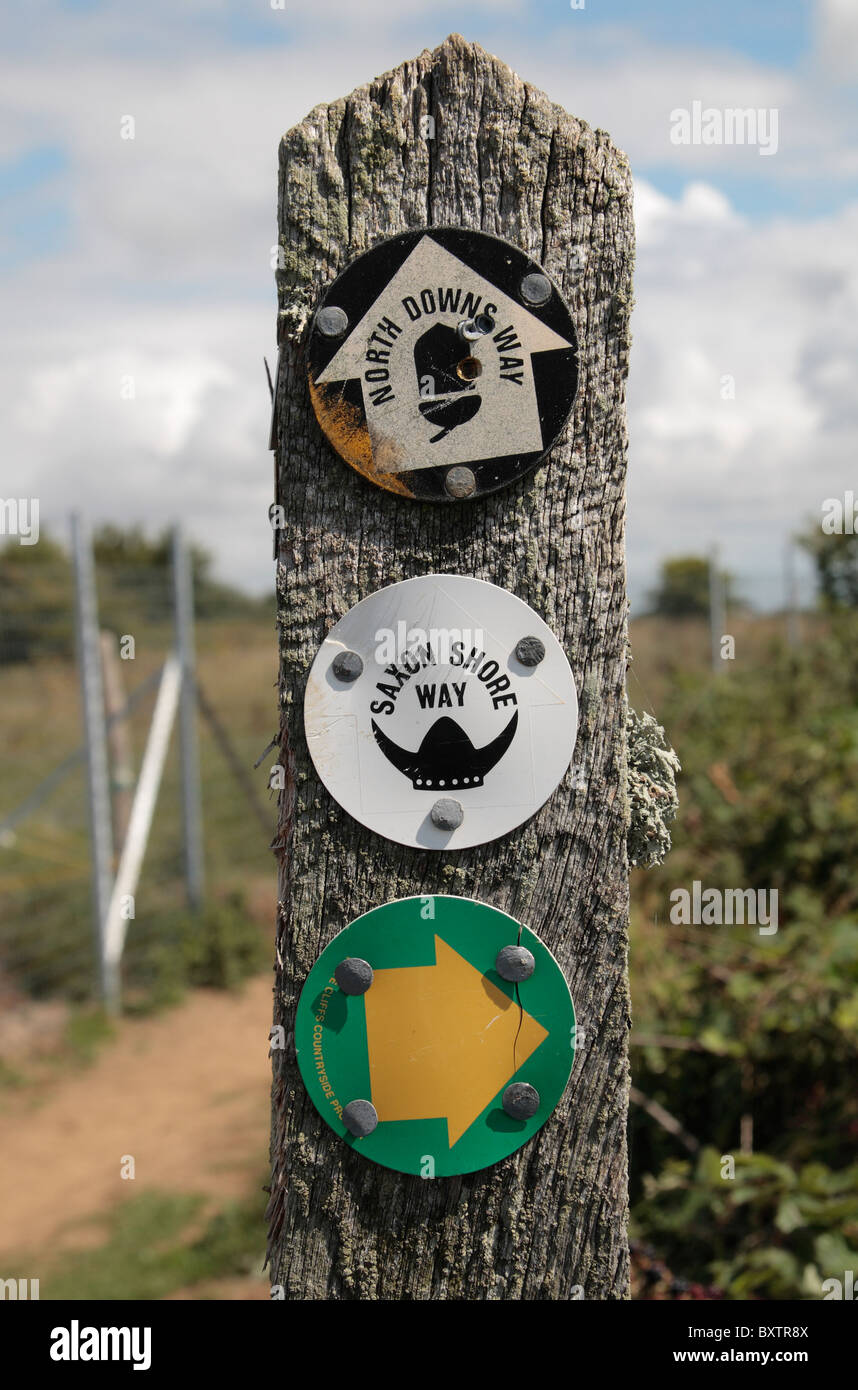 A mixture of public footpath signs (North Downs Path & Saxon Shore Way) on a post on the coastal path near Dover, Kent. Stock Photo