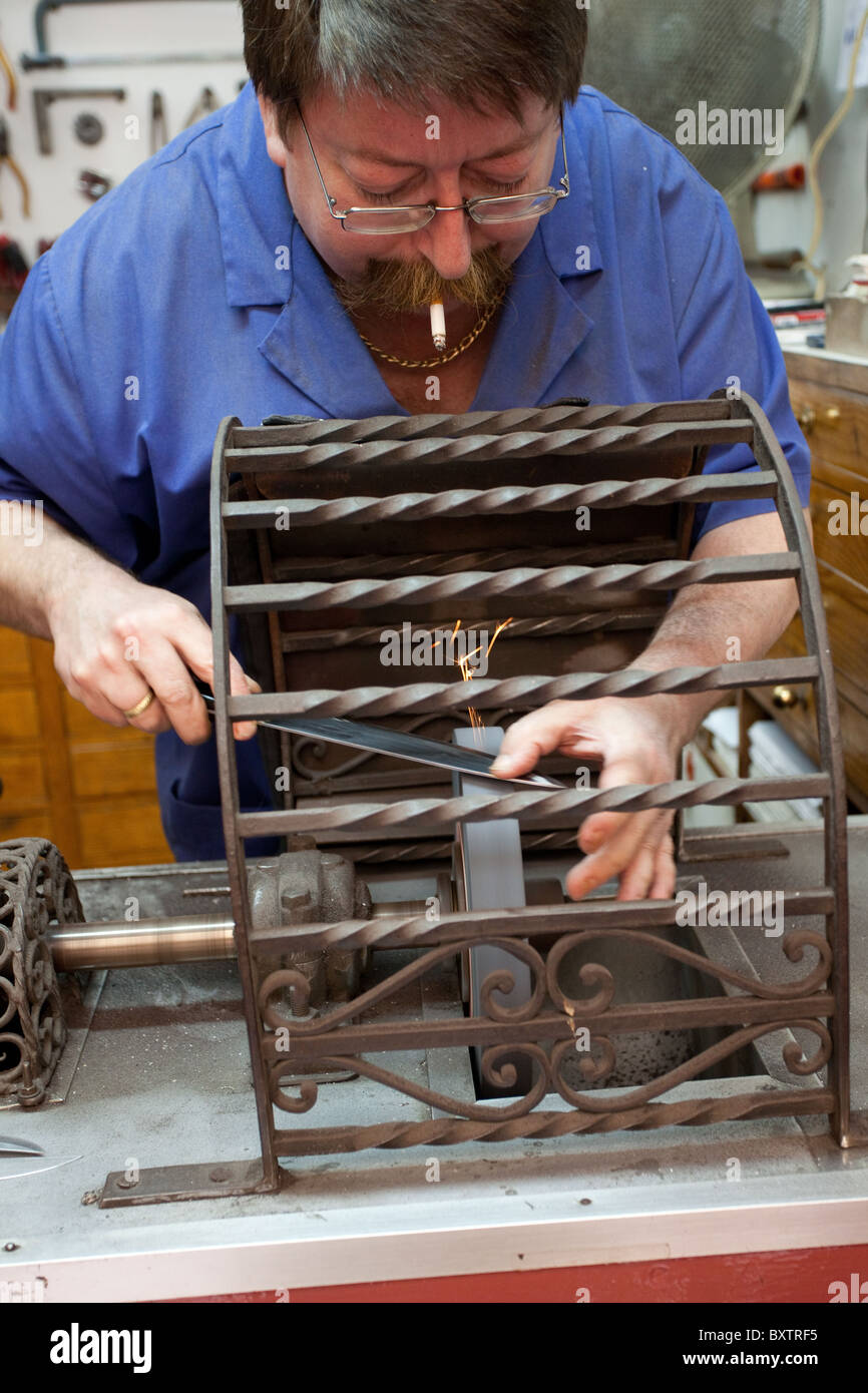Man sharpening knives Malaga hardware shop Spain. Stock Photo