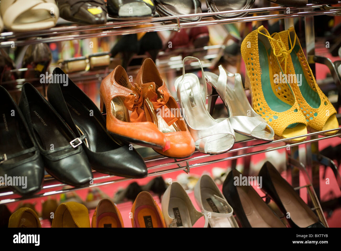 A selection of previously owned shoes in a thrift store in the Chelsea neighborhood of New York Stock Photo