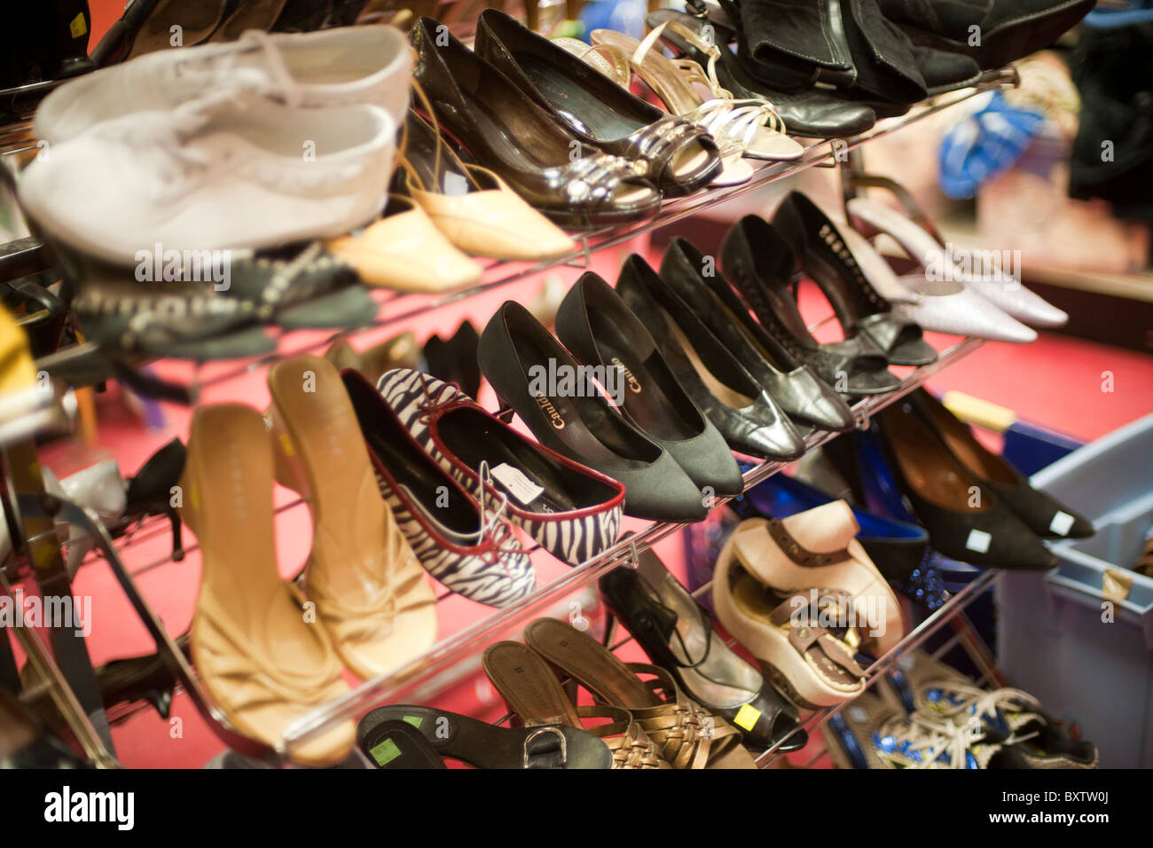 A selection of previously owned shoes in a thrift store in the Chelsea neighborhood of New York Stock Photo