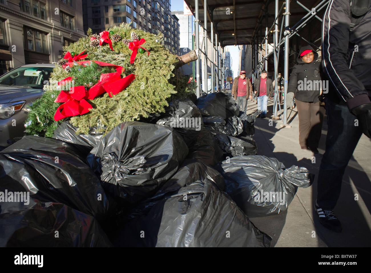 Bags of trash and a giant wreath await pickup in the Chelsea