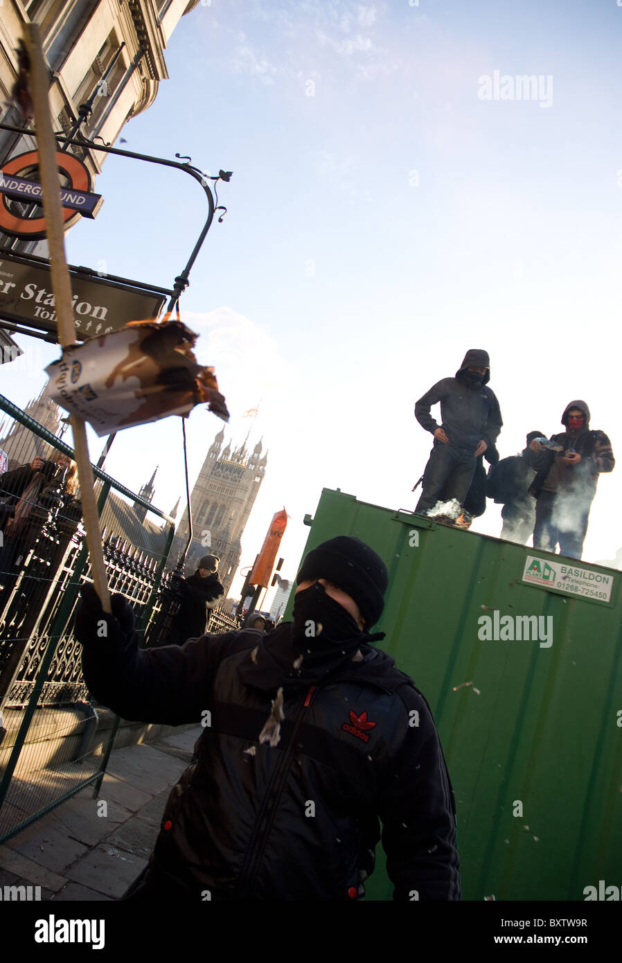 student protesters light a small fire on top of a container Stock Photo