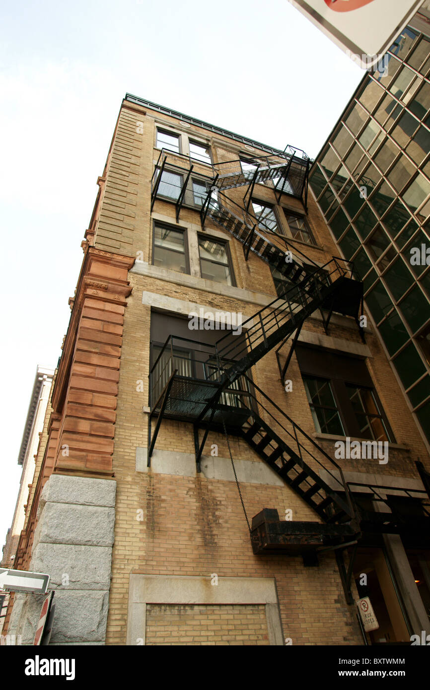 Angle shot of the back of a building showing the fire escape stairs. Stock Photo
