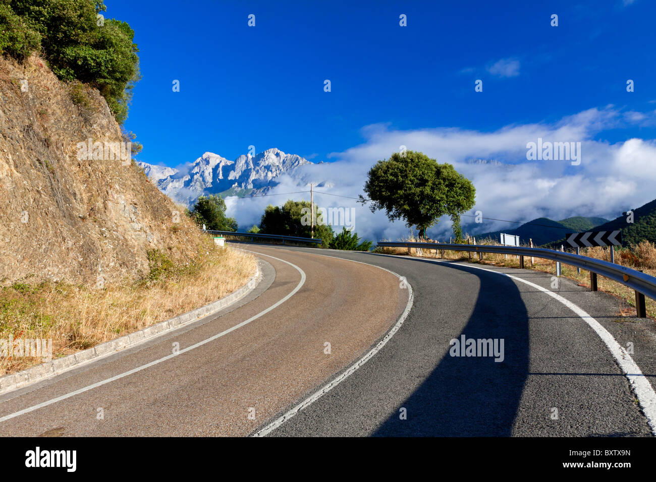 Deserted mountain road with crash barrier in the Picos de Europa Cantabria Spain Stock Photo
