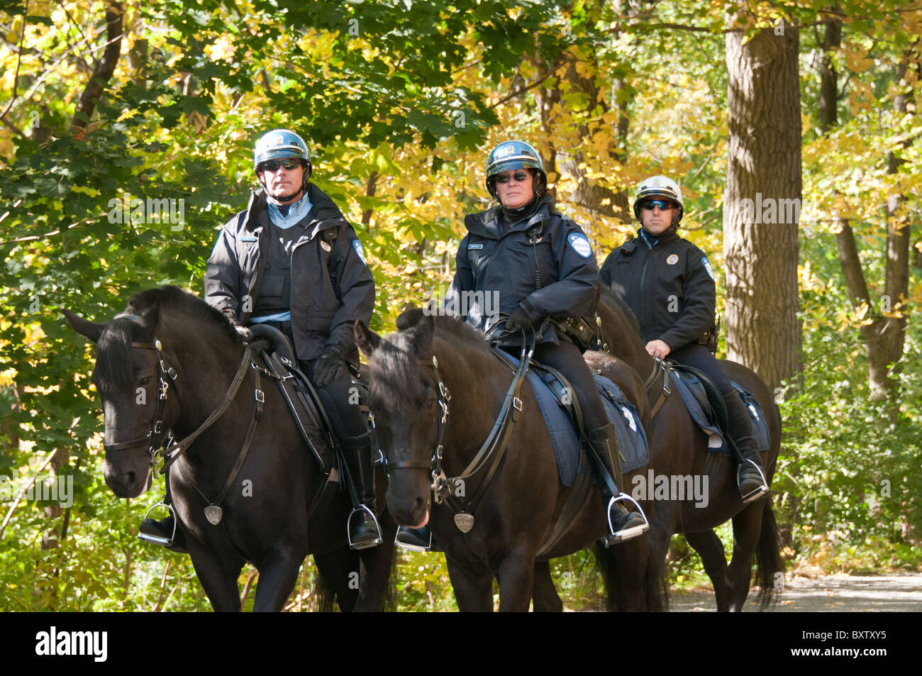 Police officers on horses Mount Royal Park Montreal canada Stock Photo