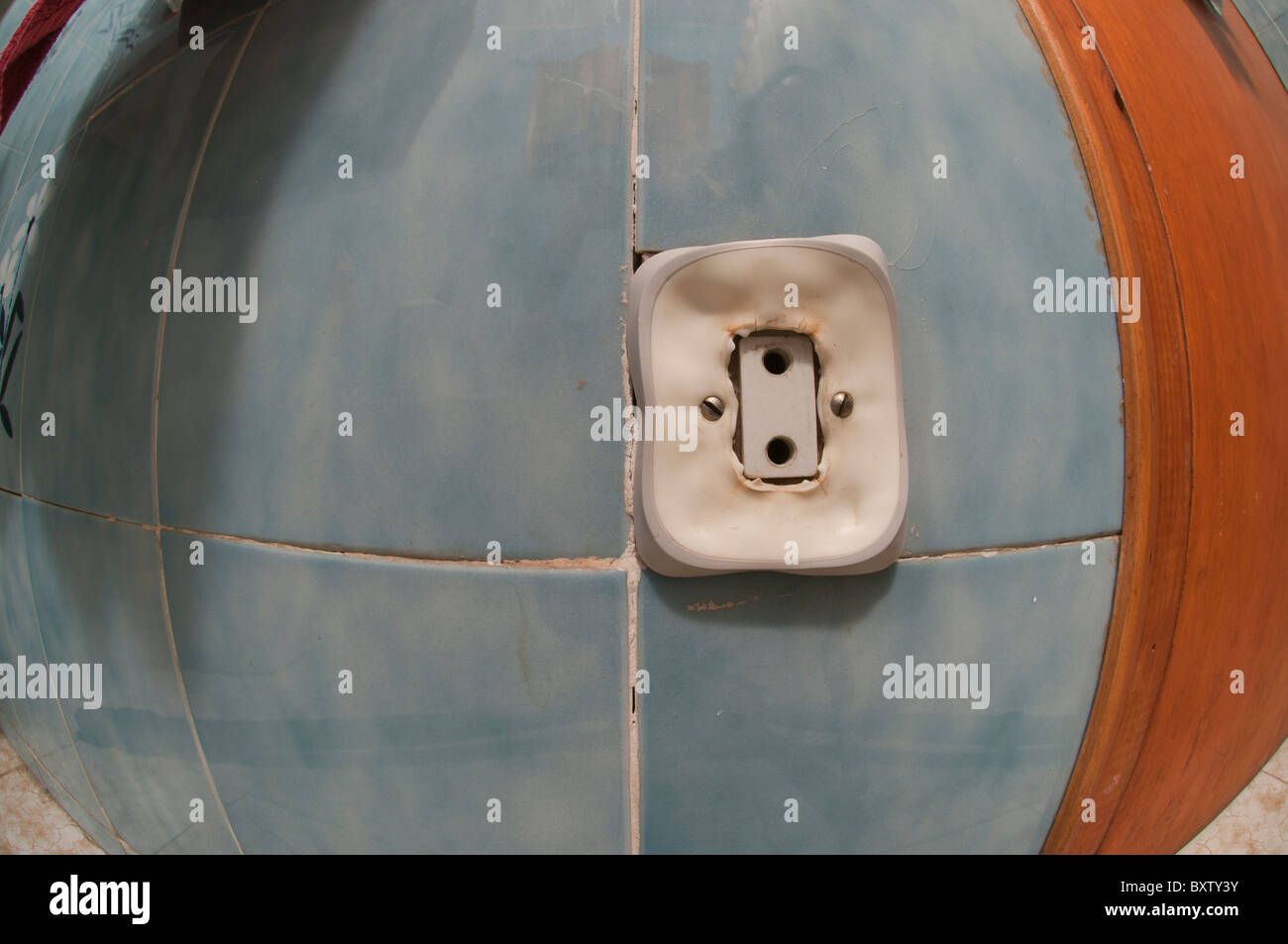Electric wall outlet in dangerous melting process due to overheating