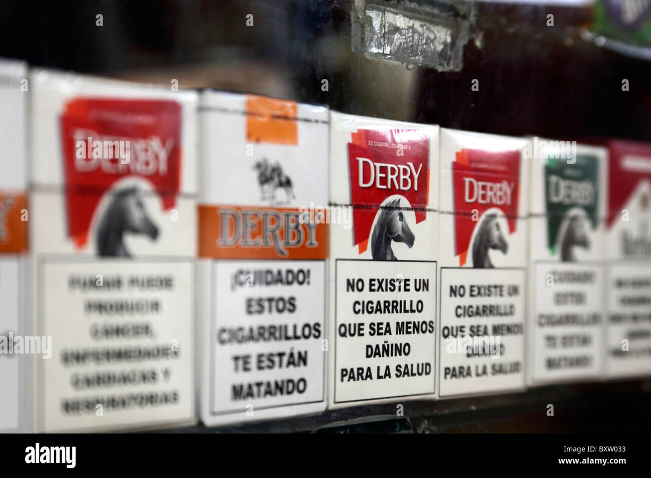 Cigarette packets of various brands on sale with health warnings in Spanish language, Bolivia Stock Photo