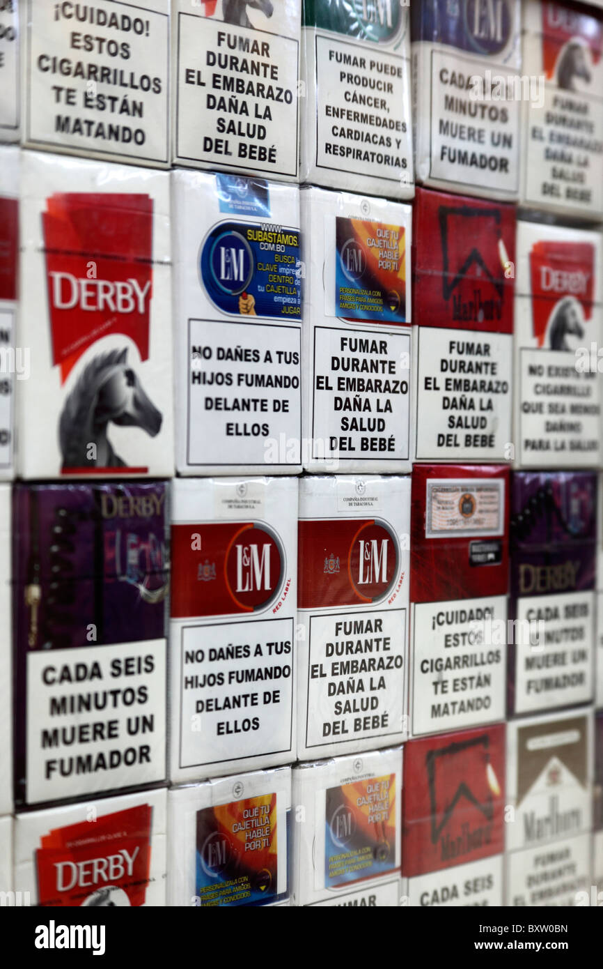 Cigarette packets of various brands on sale with health warnings in Spanish language, Bolivia Stock Photo