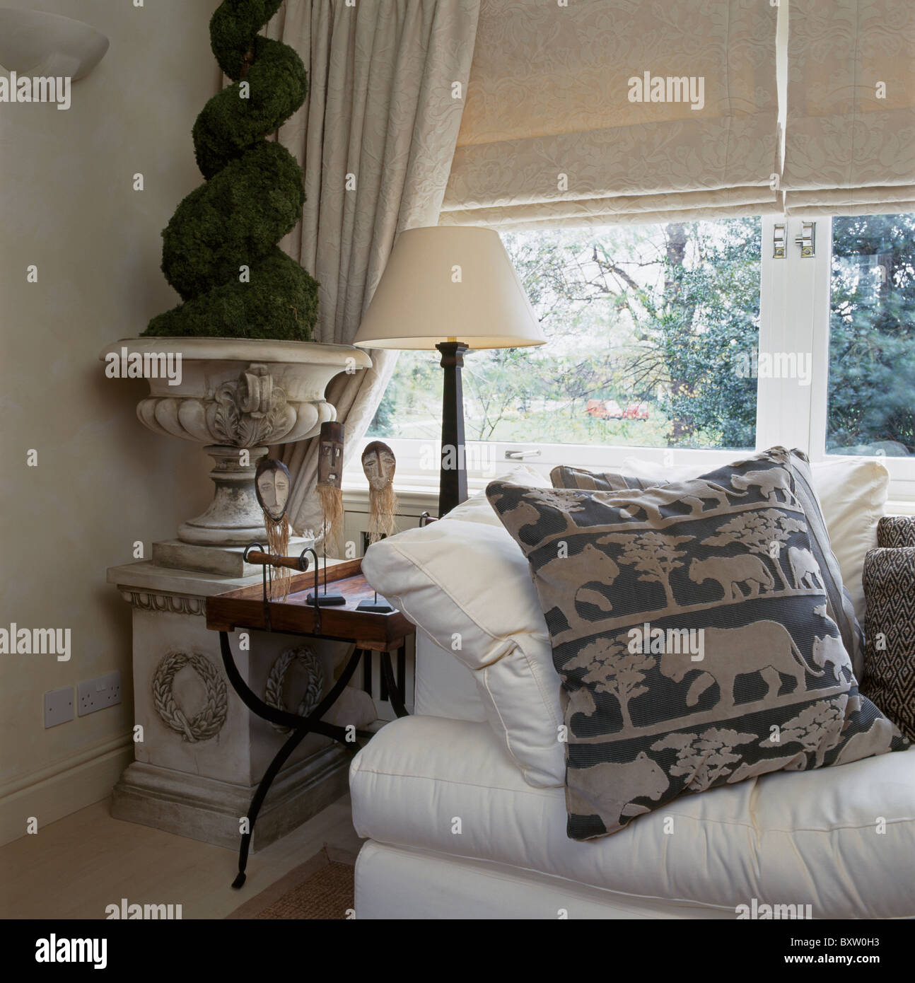 Patterned Cushion On White Sofa In Front Of Window With