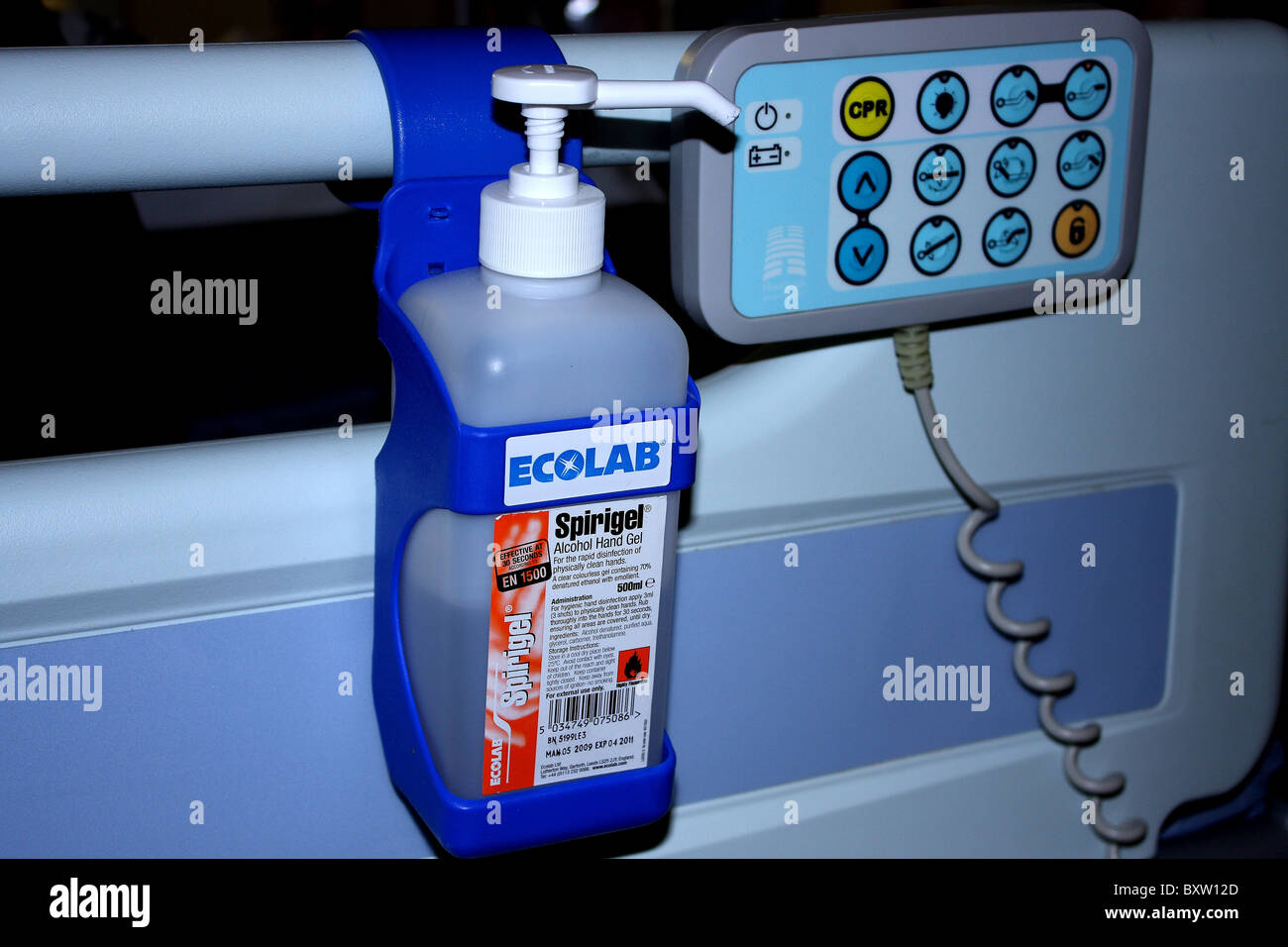 An Ecolab hand sanitiser and bed remote control in a ward at a hospital Stock Photo