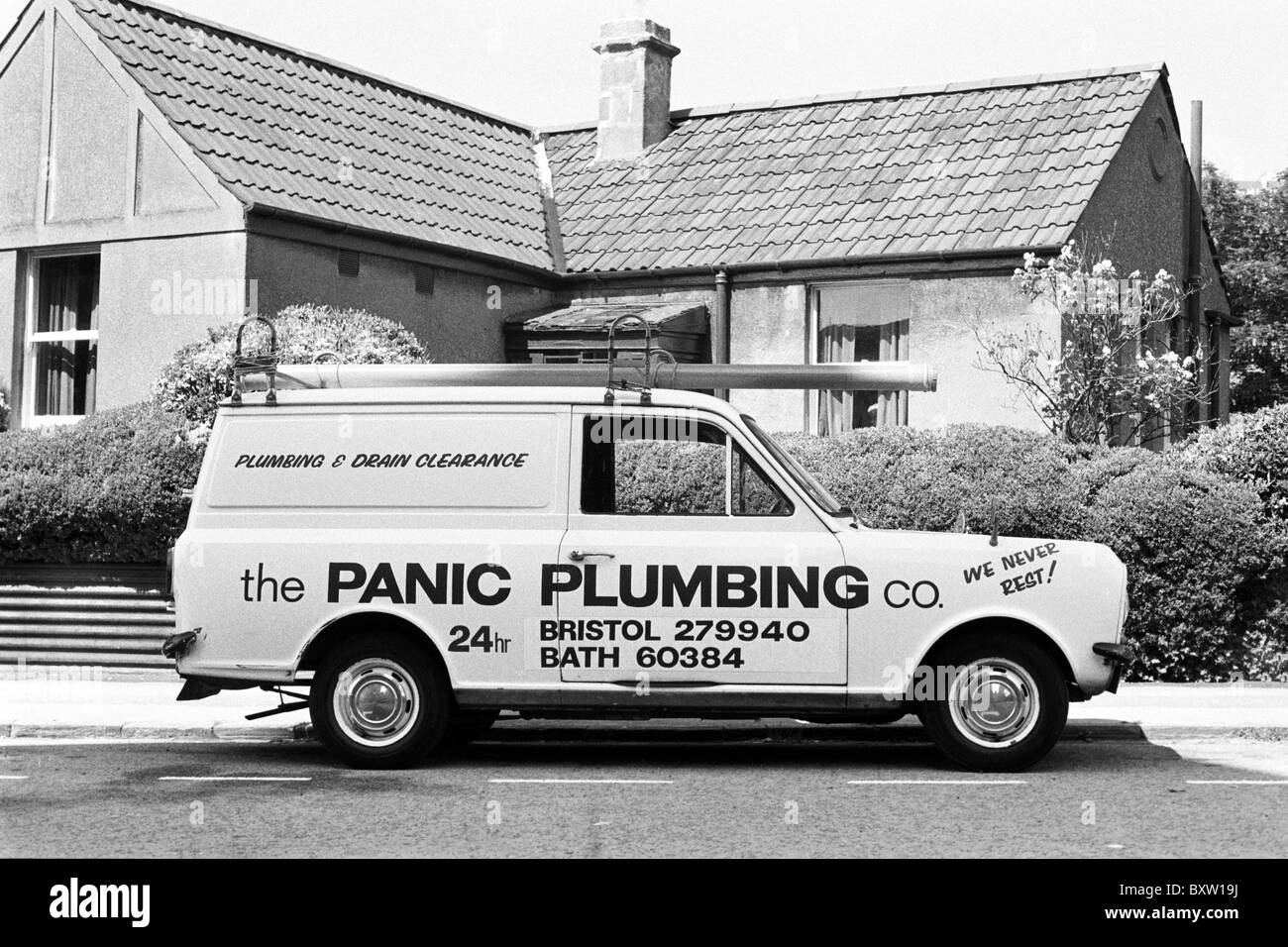 Panic Plumbing Co. vehicle parked in front of a house. Shot in 1982 on Kodak Tri-X 400 B&W film. Stock Photo