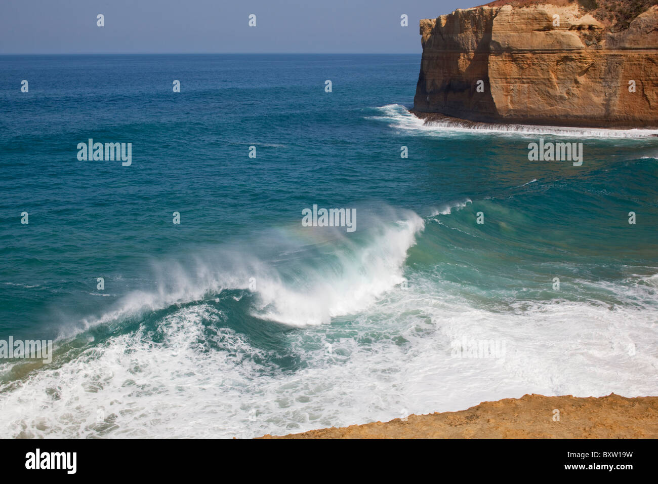 Australia, Victoria, Port Campbell, Waves crashing into steep cliffs lining Tasman Sea coast along Great Ocean Road Stock Photo