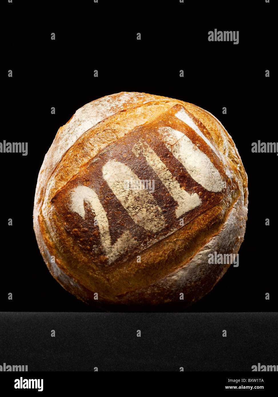 round loaf of bread dusted with the year date Stock Photo Alamy