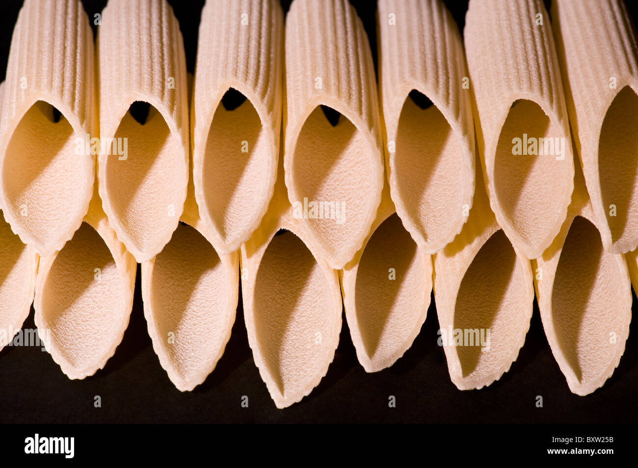 Macaronis on black background, Makkaroni auf schwarzem Hintergrund Stock Photo