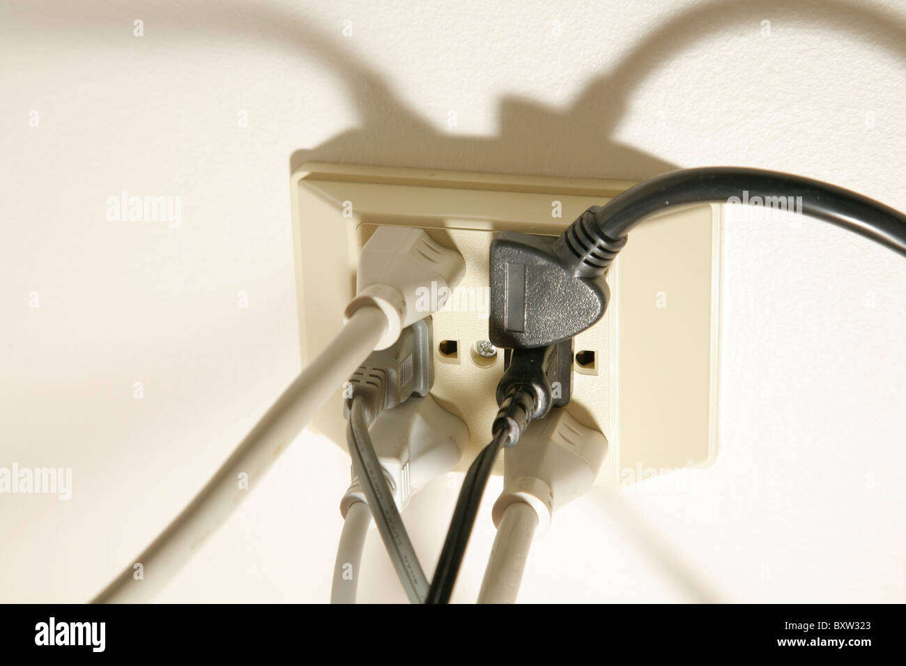 Multiple power cords plugged into an American 120 volt electric outlet