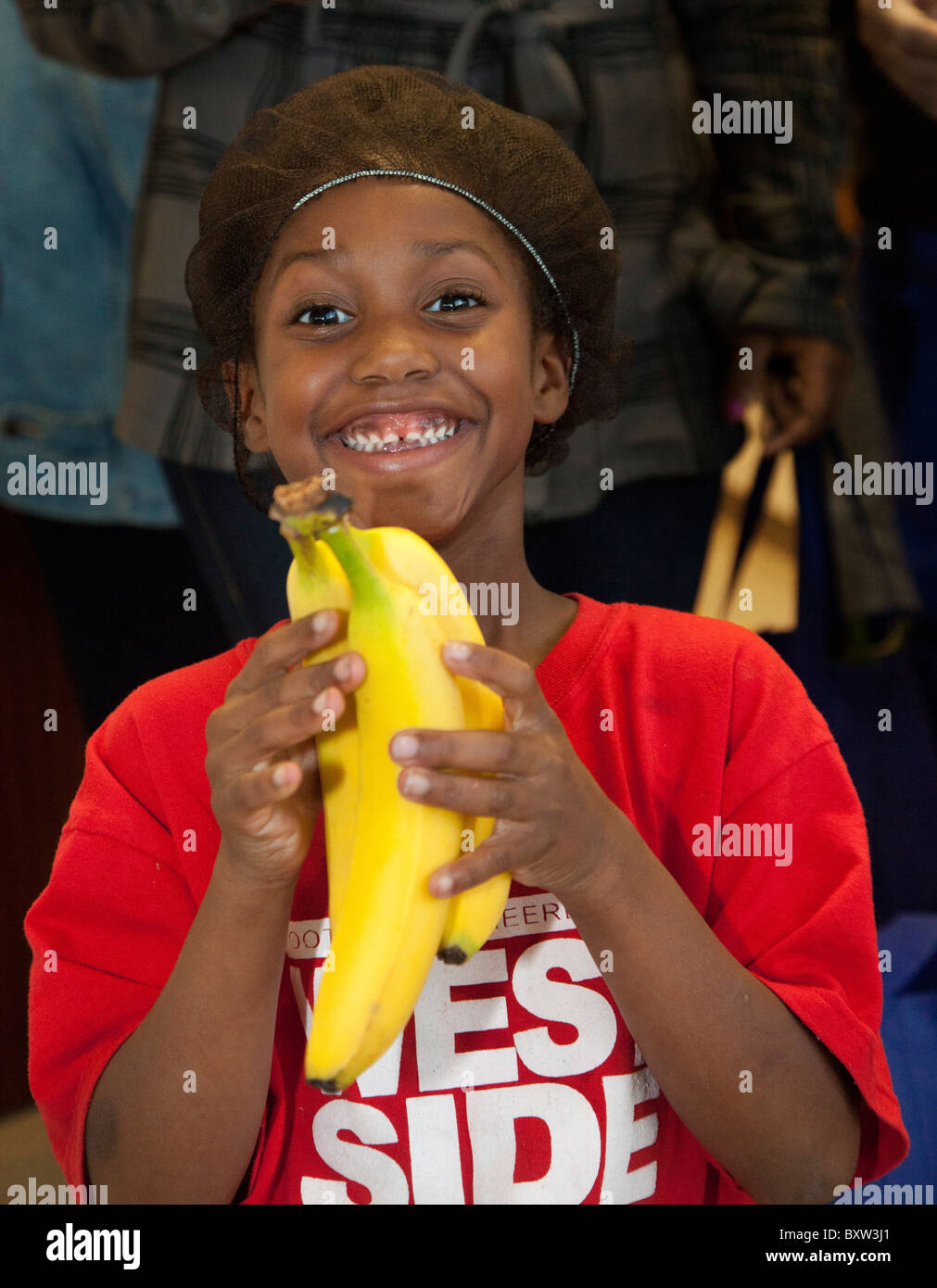 Child Holds Bunch of Bananas Stock Photo