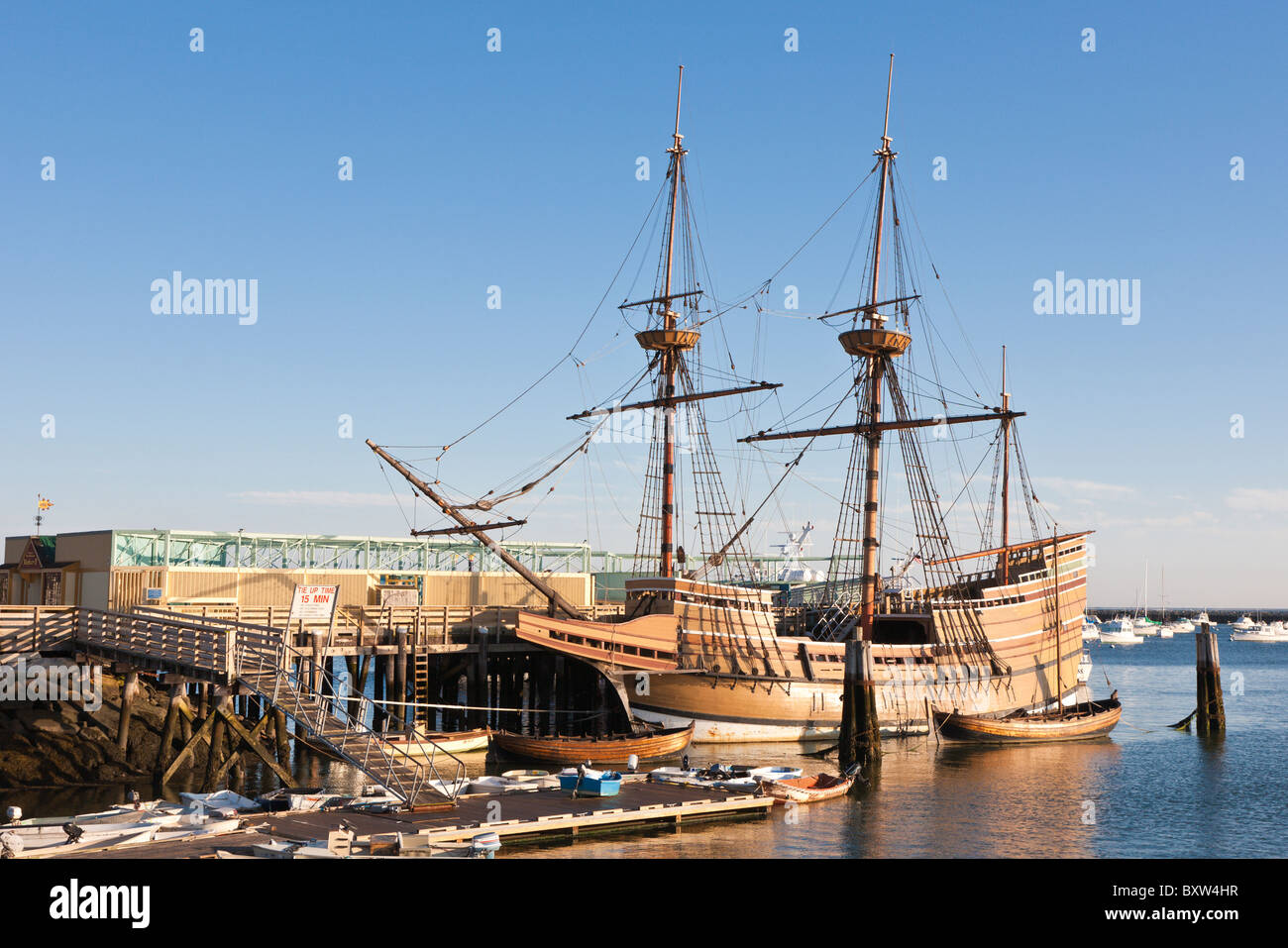 Mayflower II and other boats moored in Plymouth Harbor at dawn in Plymouth Massachusetts Stock Photo